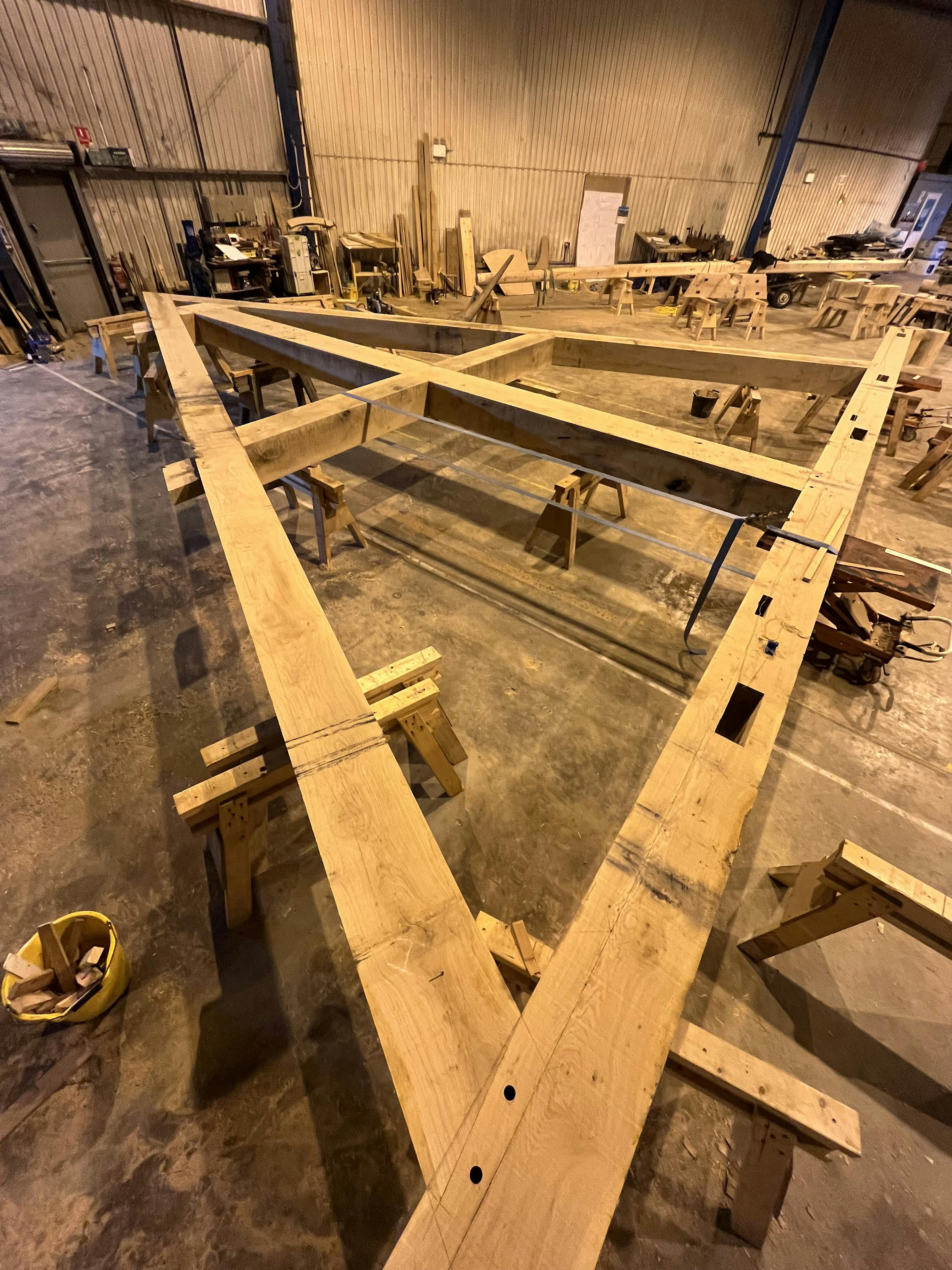 The frame of a full scale working oak and ash trebuchet during manufacturing in a workshop