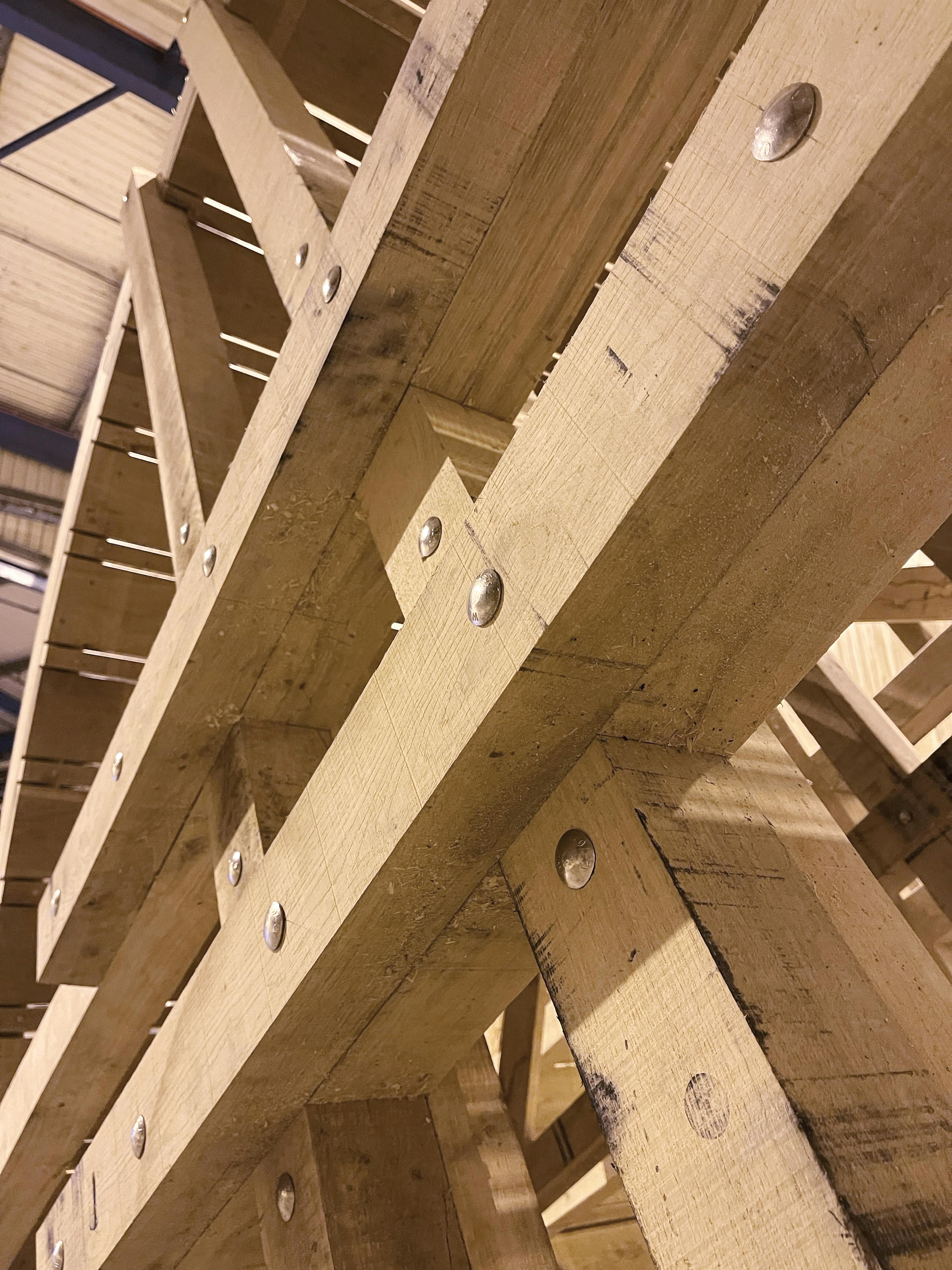 A close up of a section of the wheel of a full scale working oak and ash trebuchet during manufacturing in a workshop