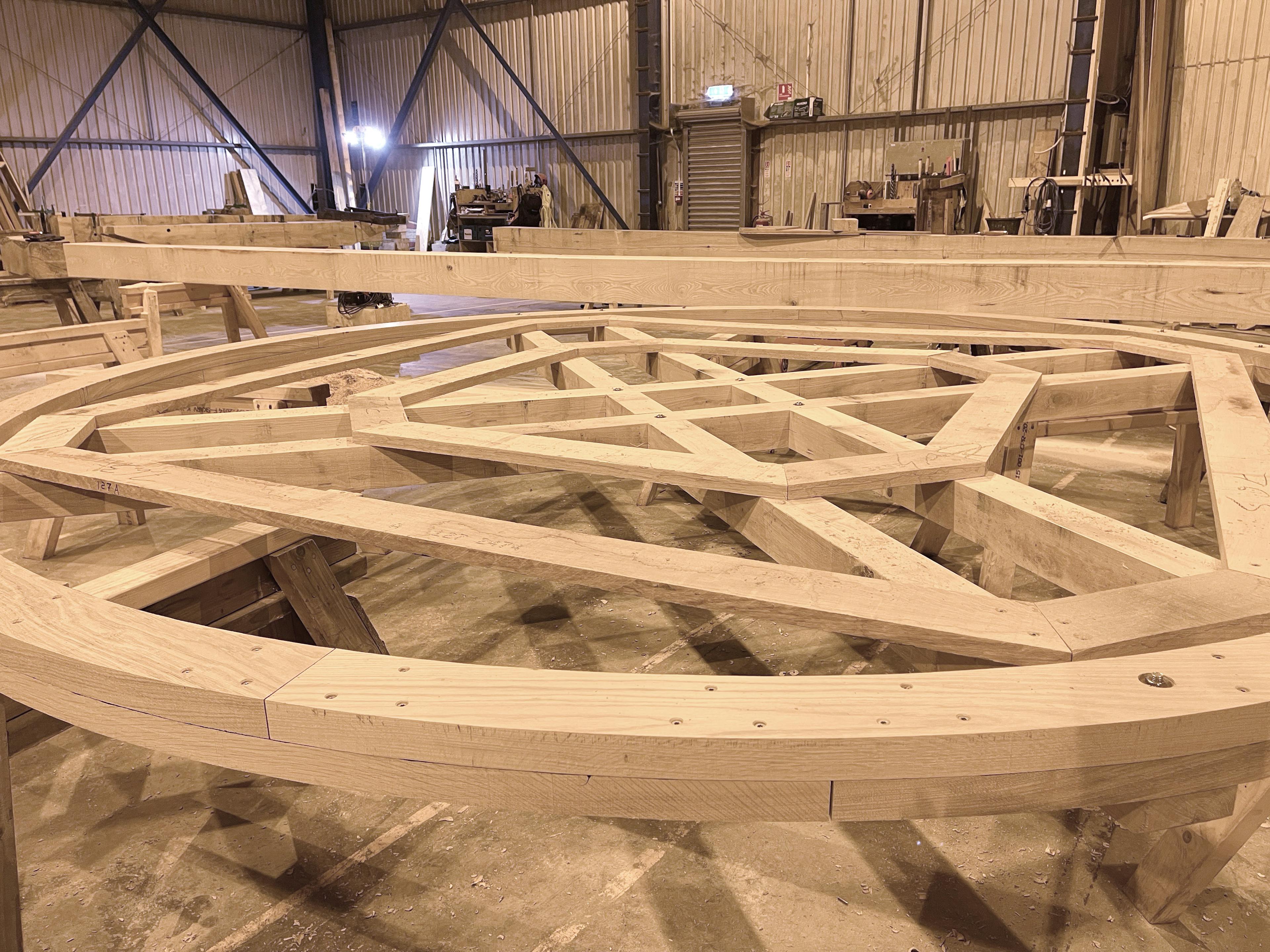 A close up of a section of the wheel of a full scale working oak and ash trebuchet during manufacturing in a workshop