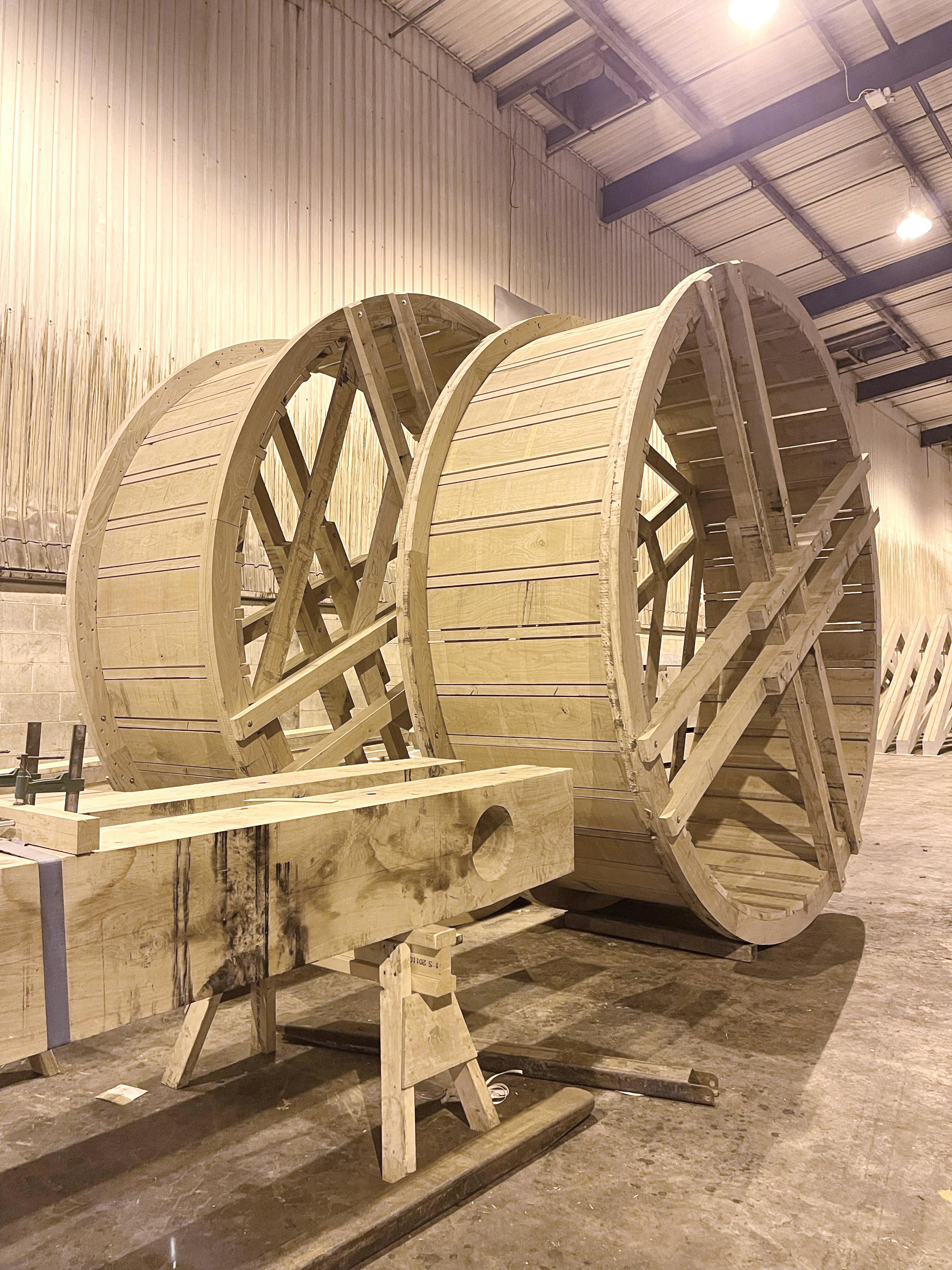 The two wheels of a full scale working oak and ash trebuchet during manufacturing in a workshop