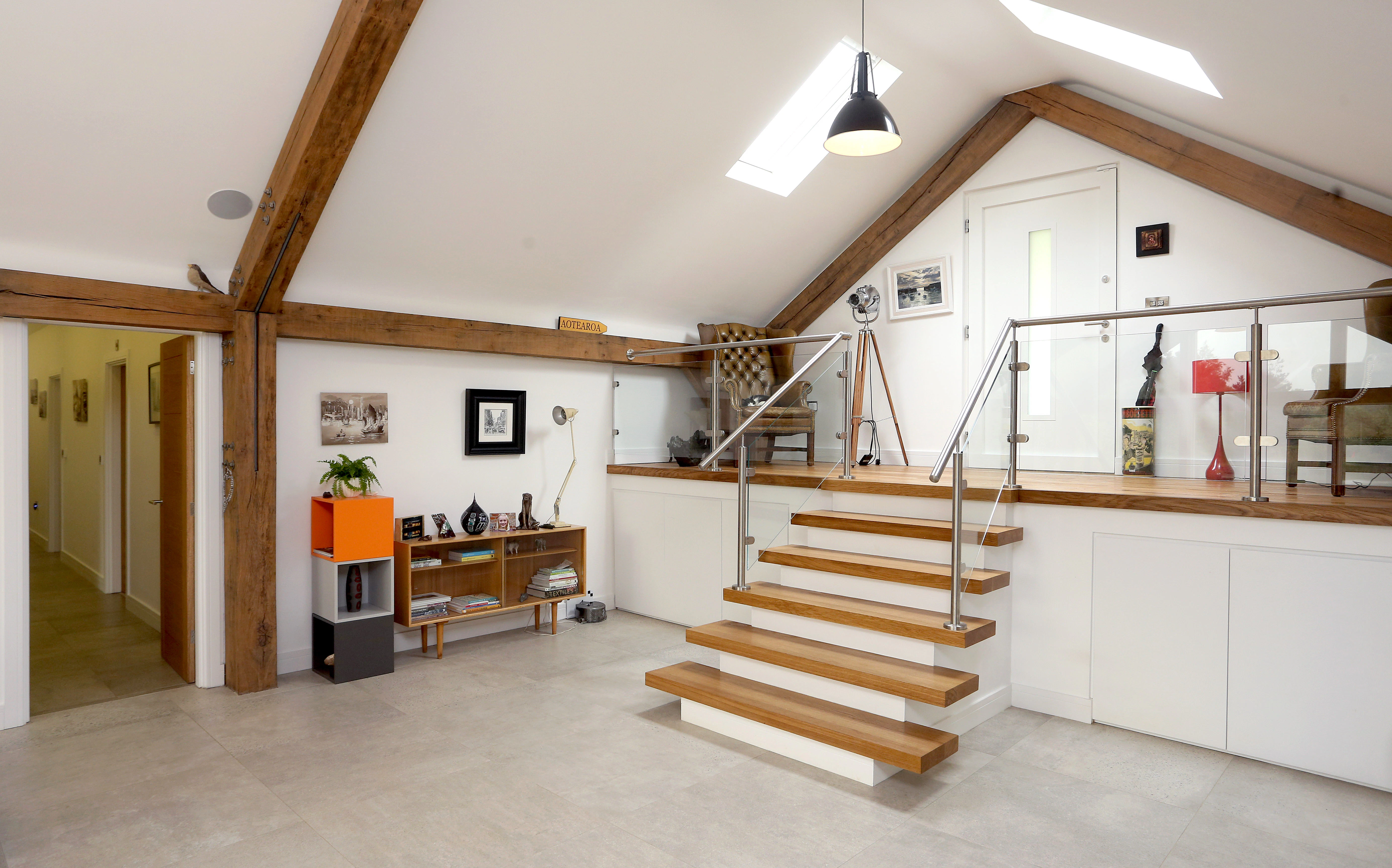 Interior view of an oak-framed bungalow with an open-plan living space and vaulted ceilings