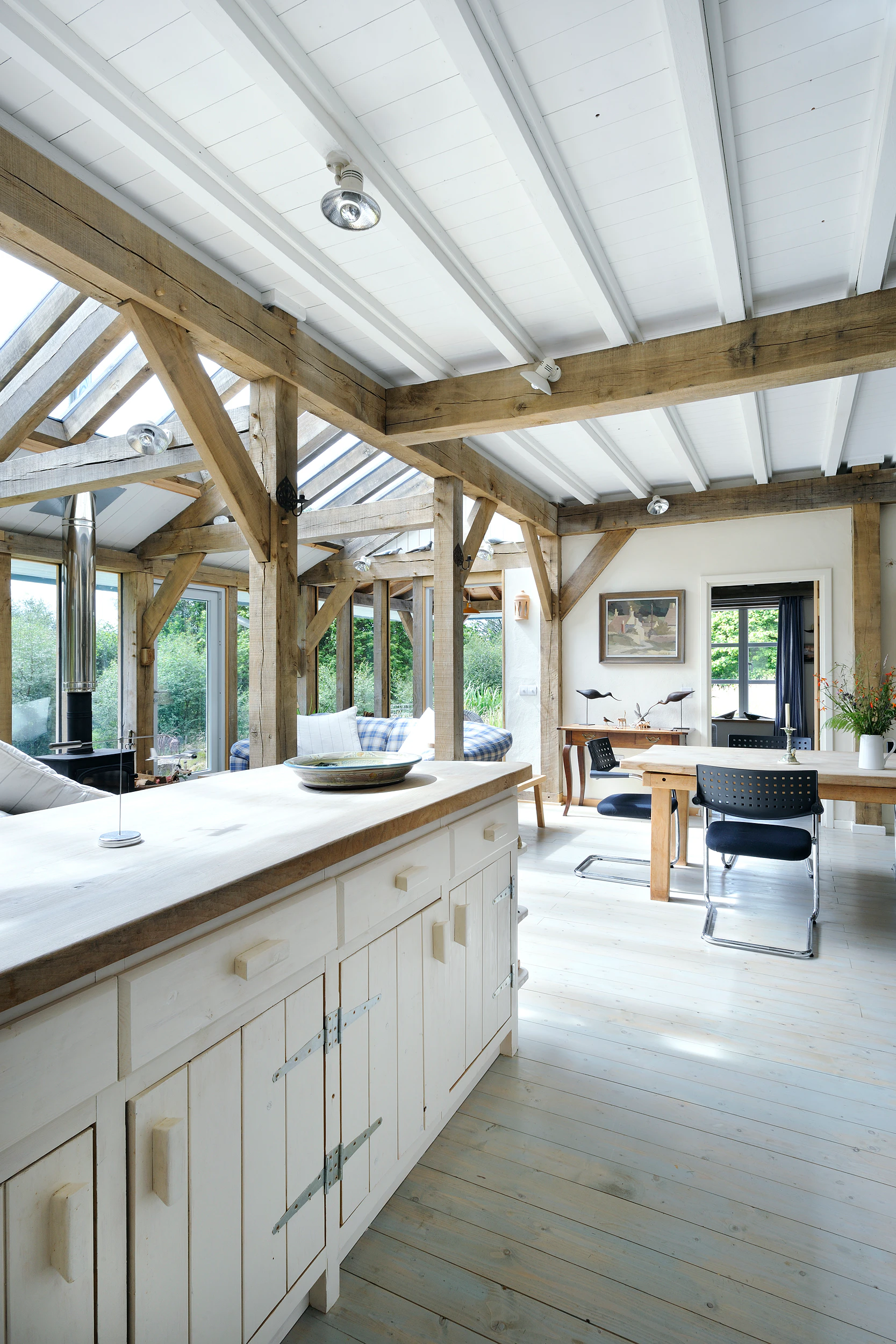 Interior view of an open-plan, oak-framed farmhouse-style kitchen