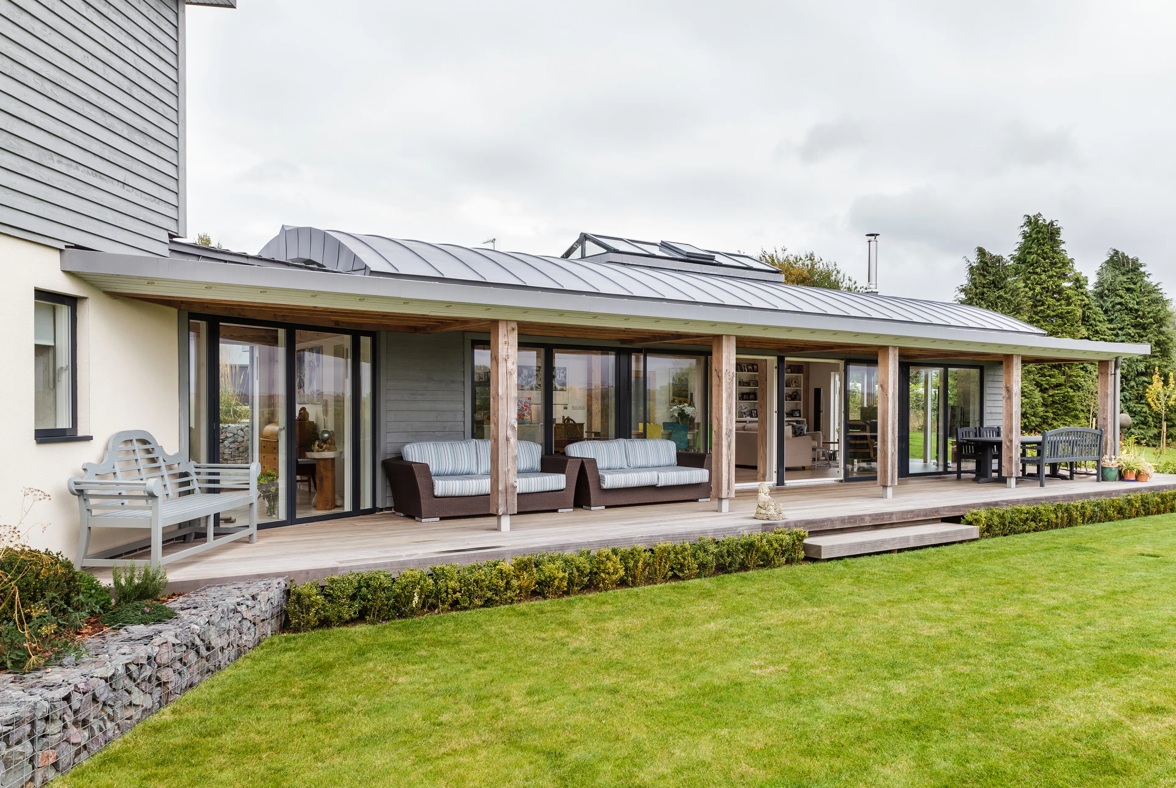 The veranda of a new build contemporary family home featuring a structural Douglas fir frame