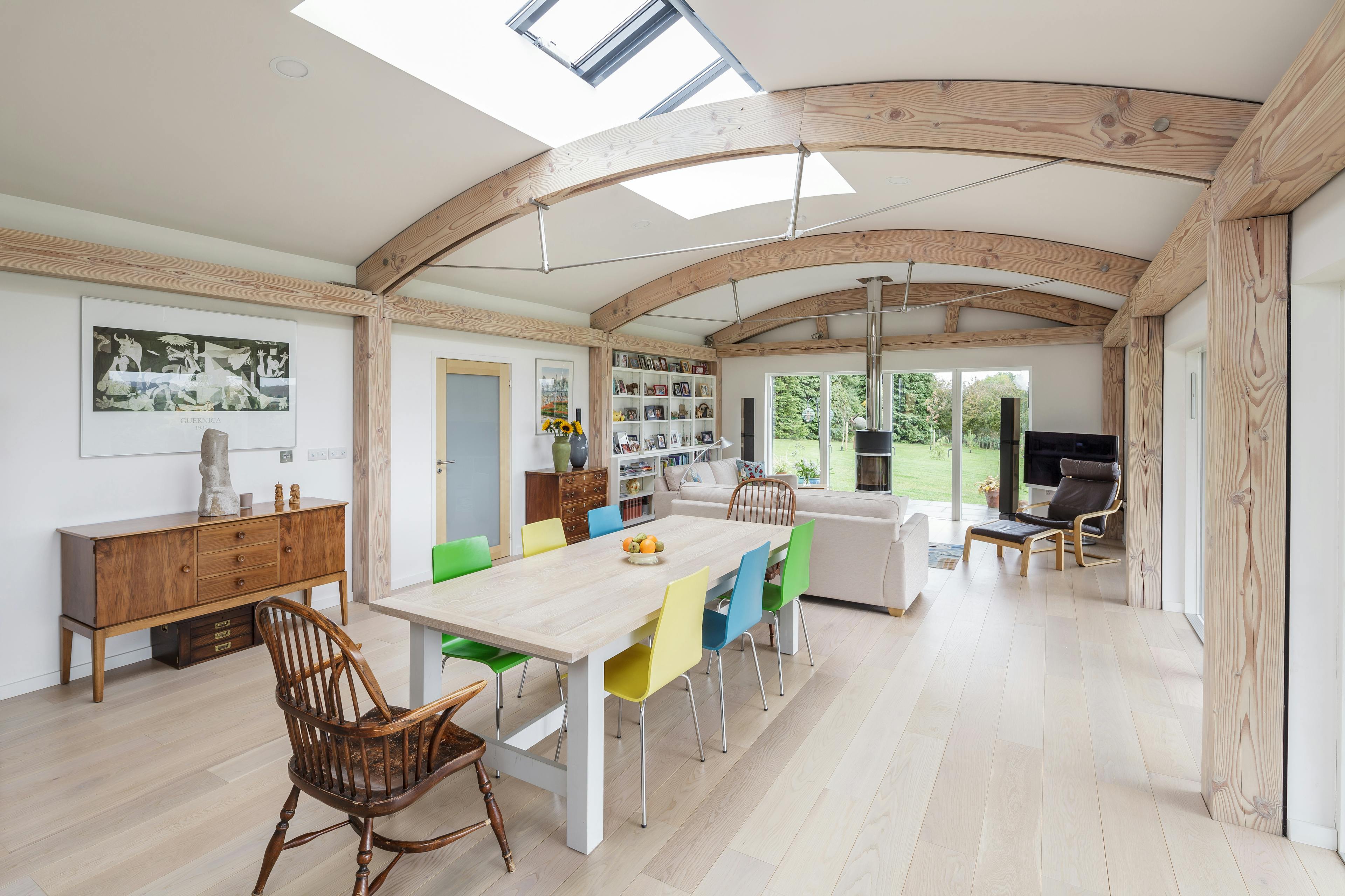 The living room of a Douglas fir framed home with curved roof
