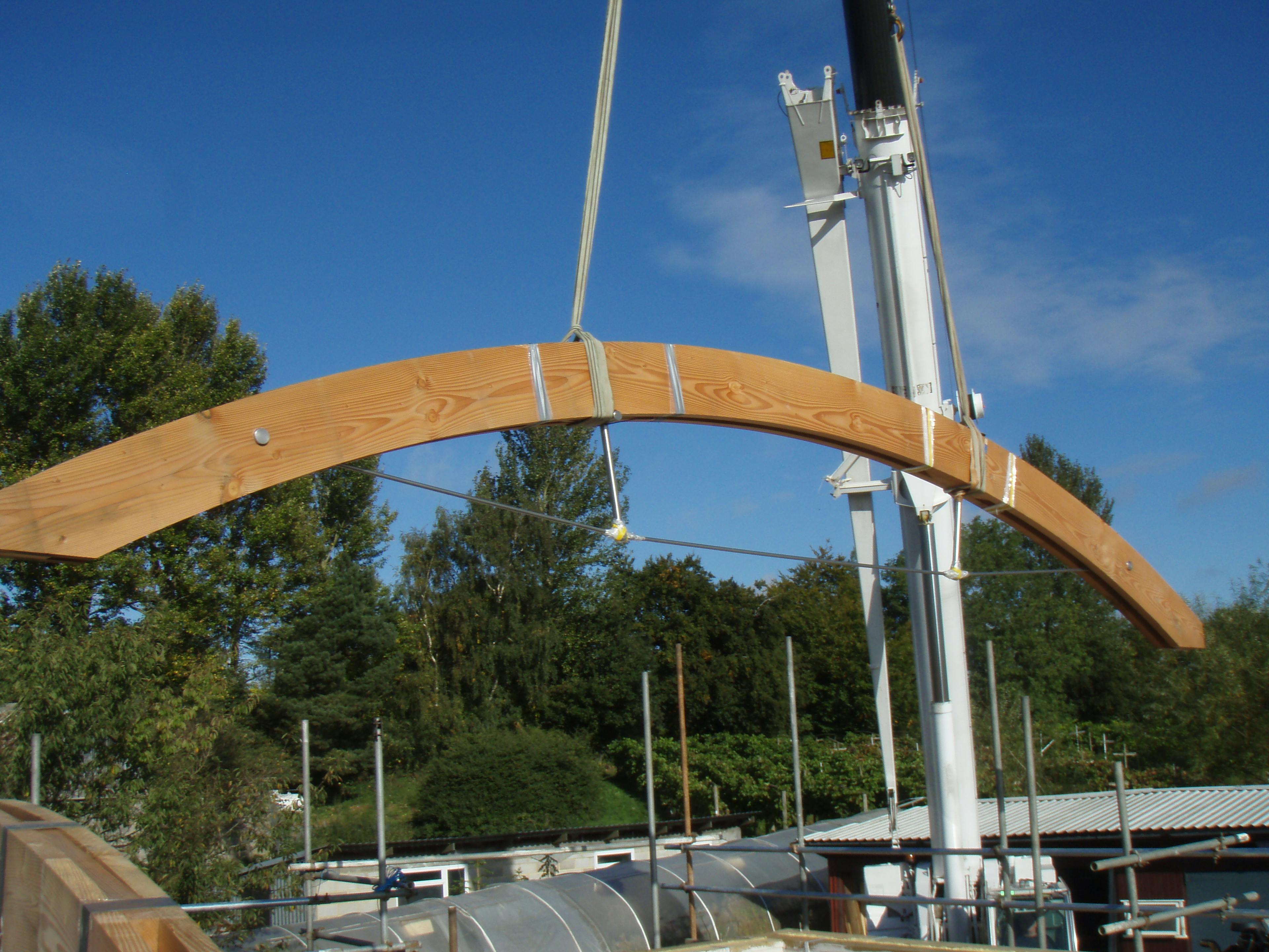 Lifting a curved Douglas fir beam into place on-site
