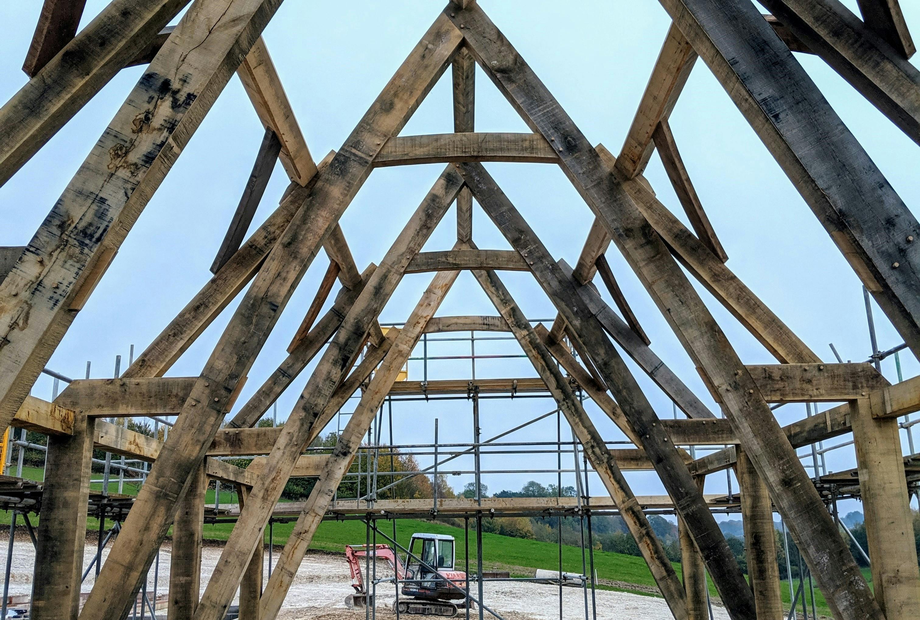 A cruck truss frame during installation