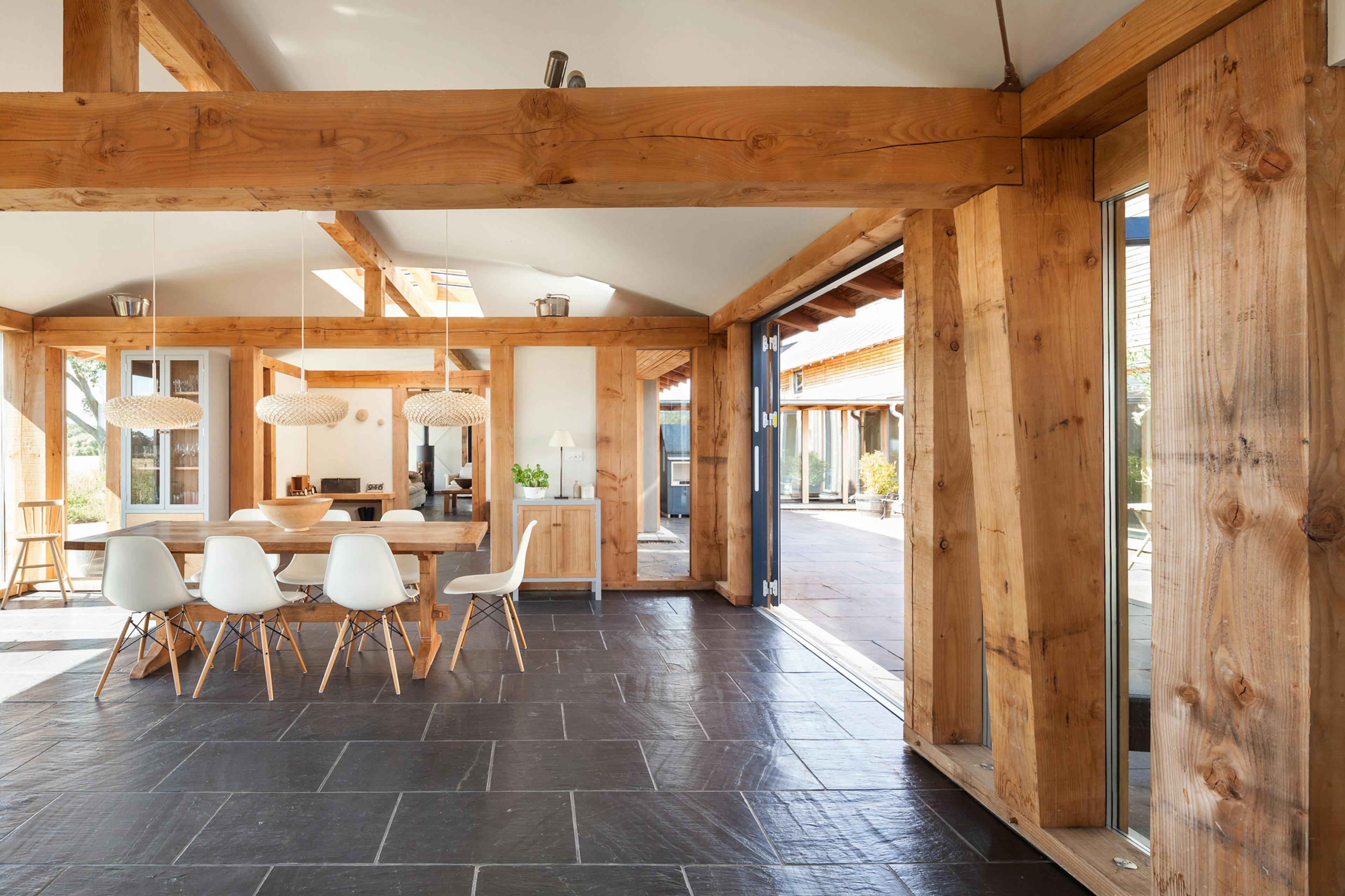The dining room in a Douglas fir framed farmhouse with a curved ceiling