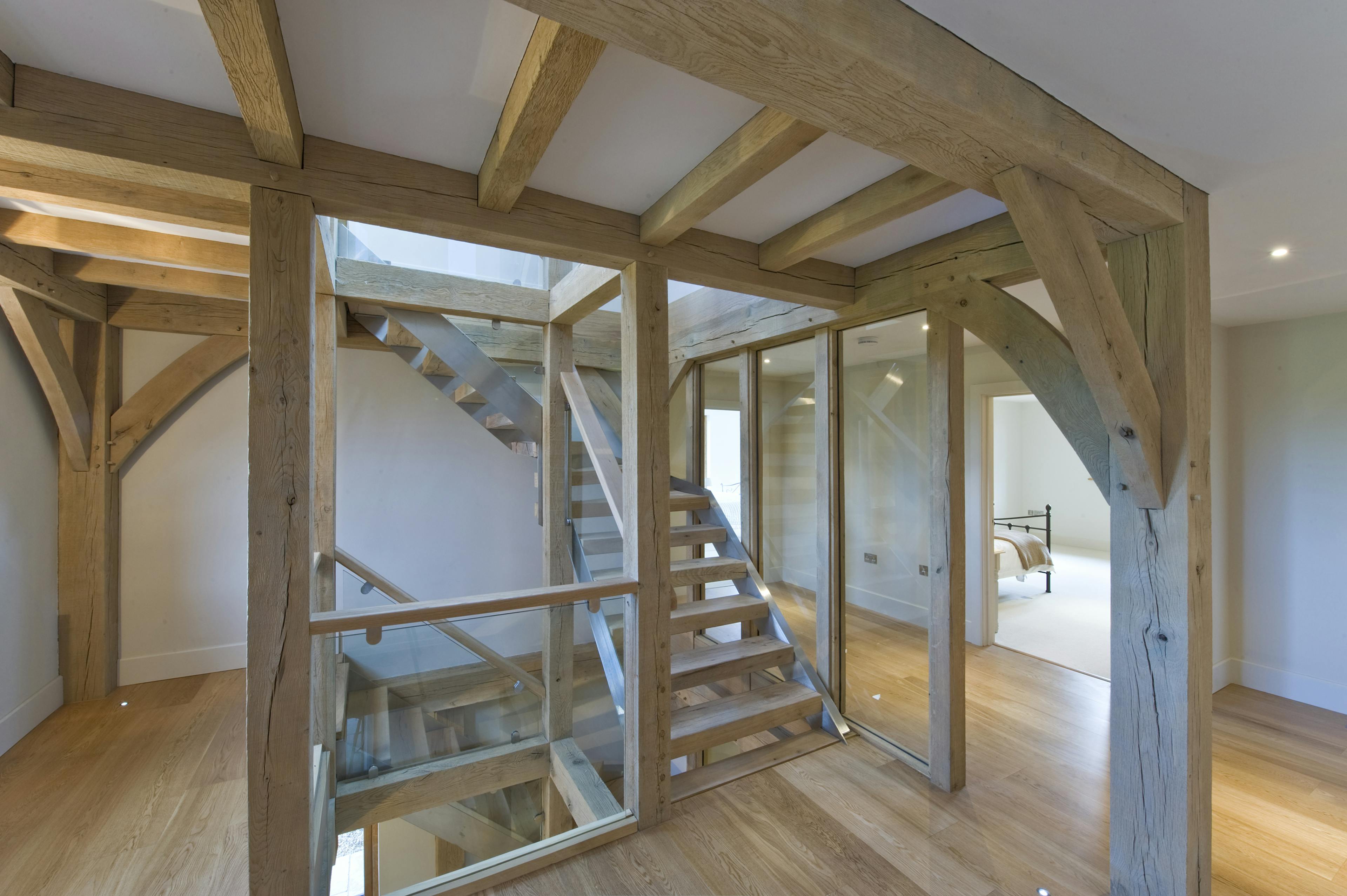 Interior view of a three-story oak-framed staircase