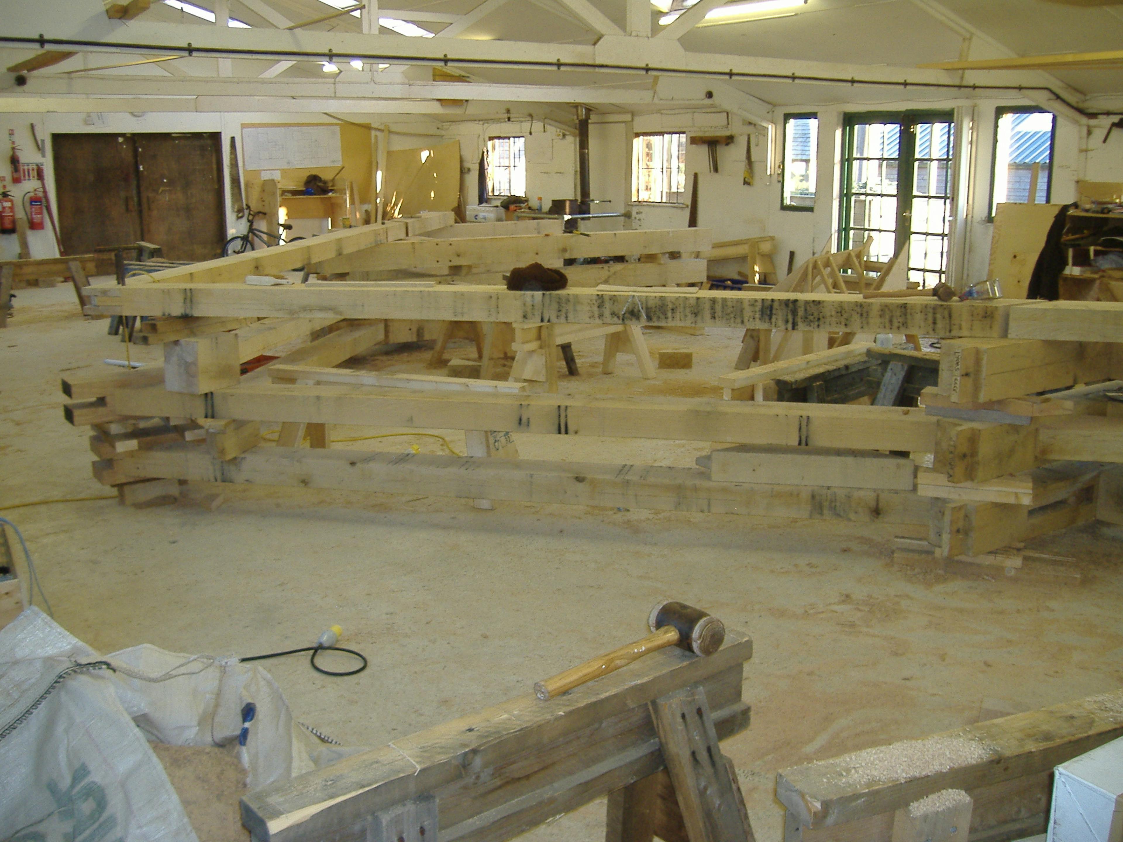 Preassembled oak-framed trusses in the workshop, ready for shipment