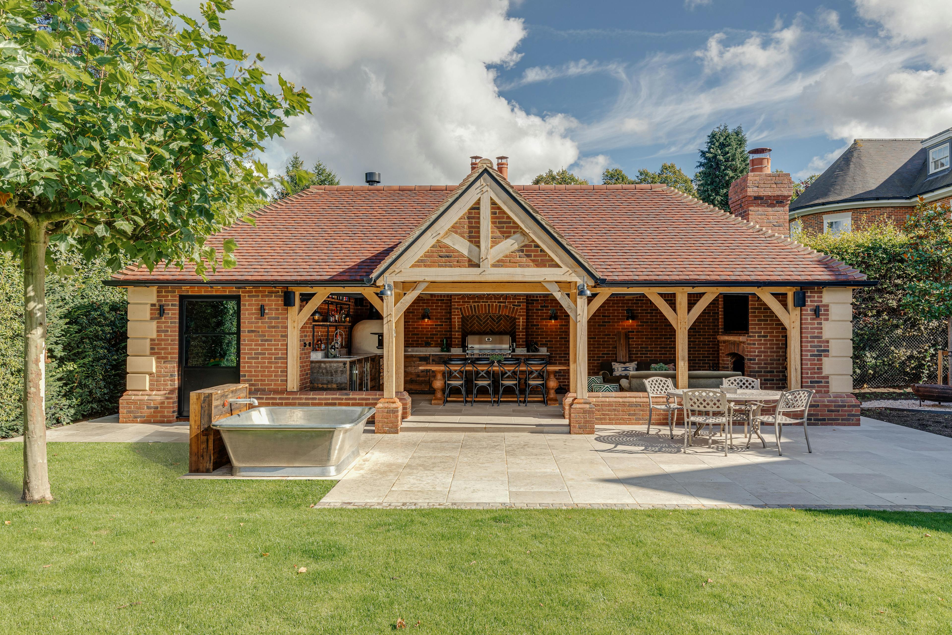 An oak frame outdoor bar and kitchen with dining area and sitting area