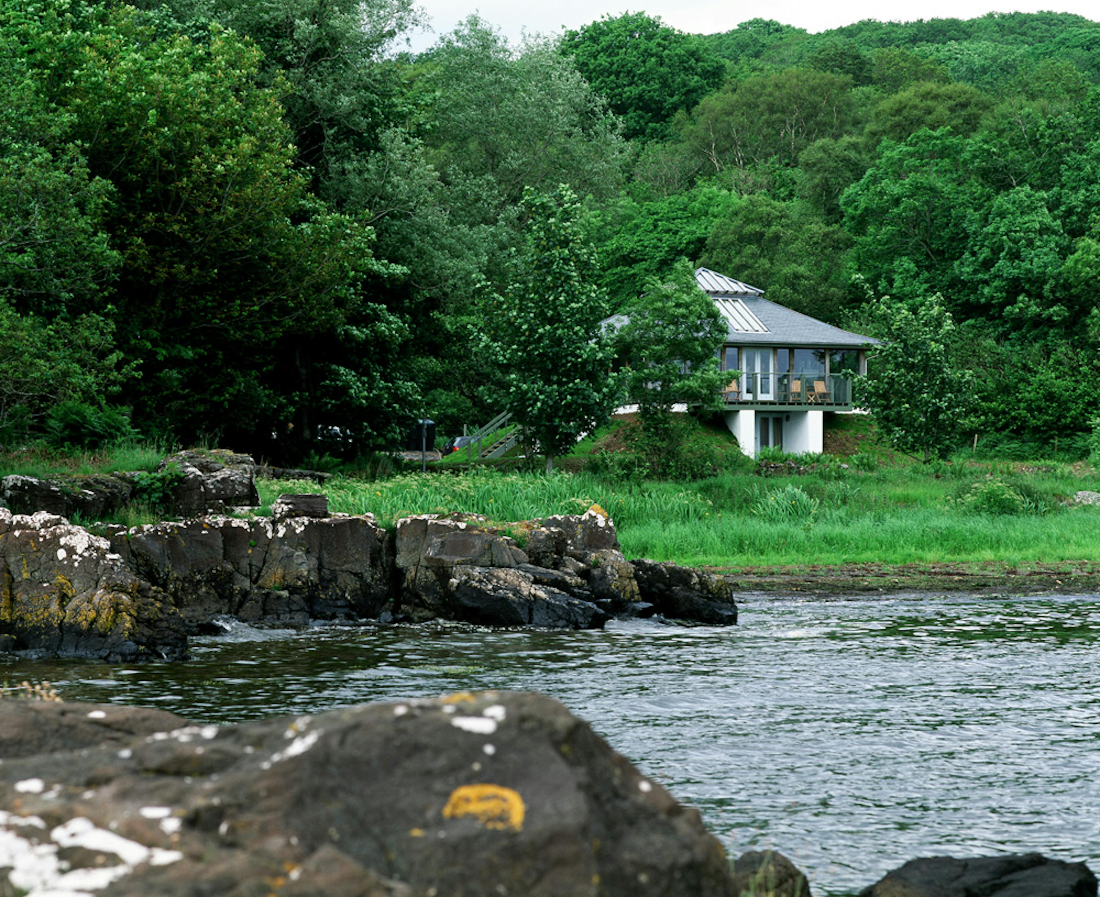 Exterior view of a two-story oak-framed home with stunning coastal views