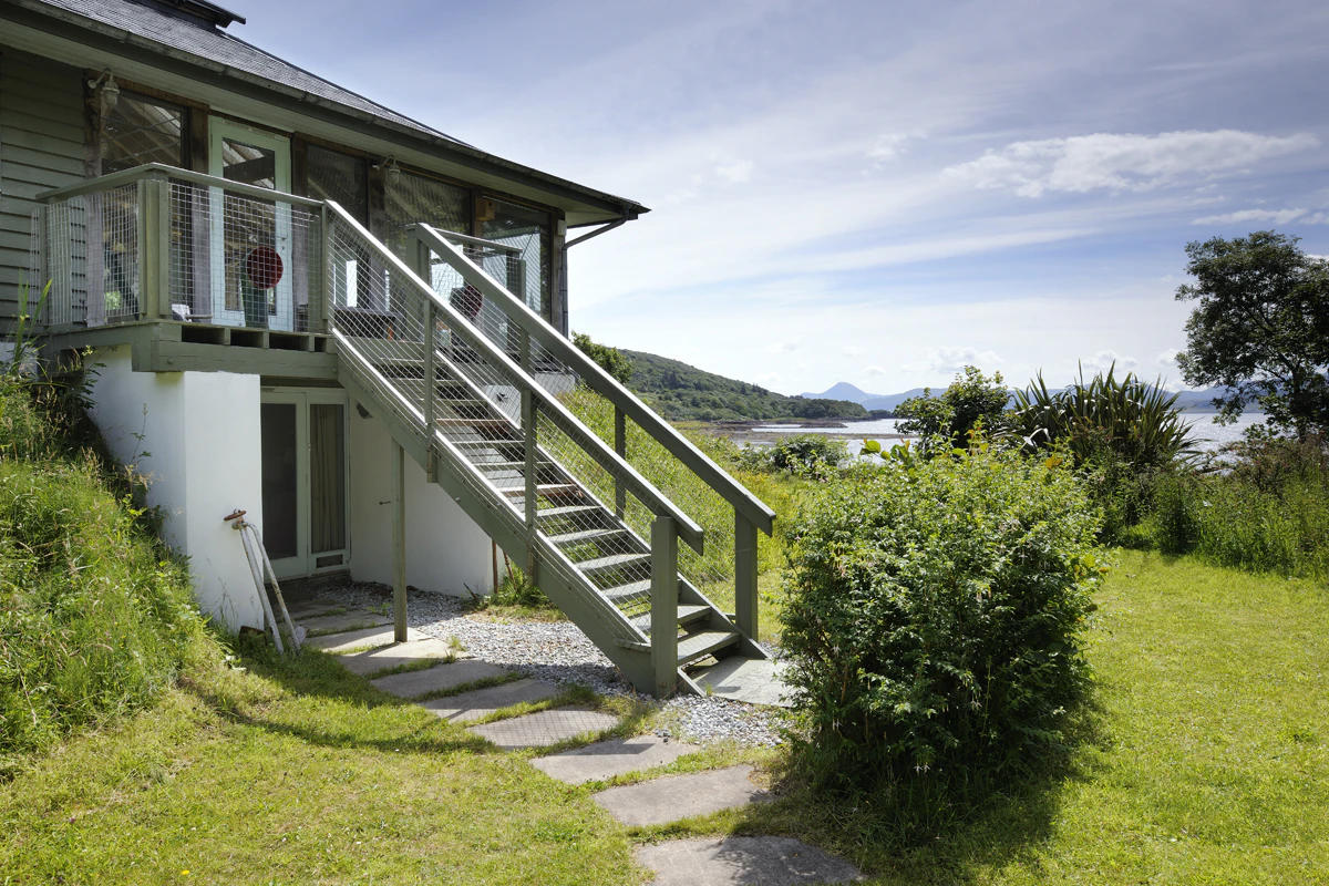 Exterior view of a two-story oak-framed home offering panoramic coastal views