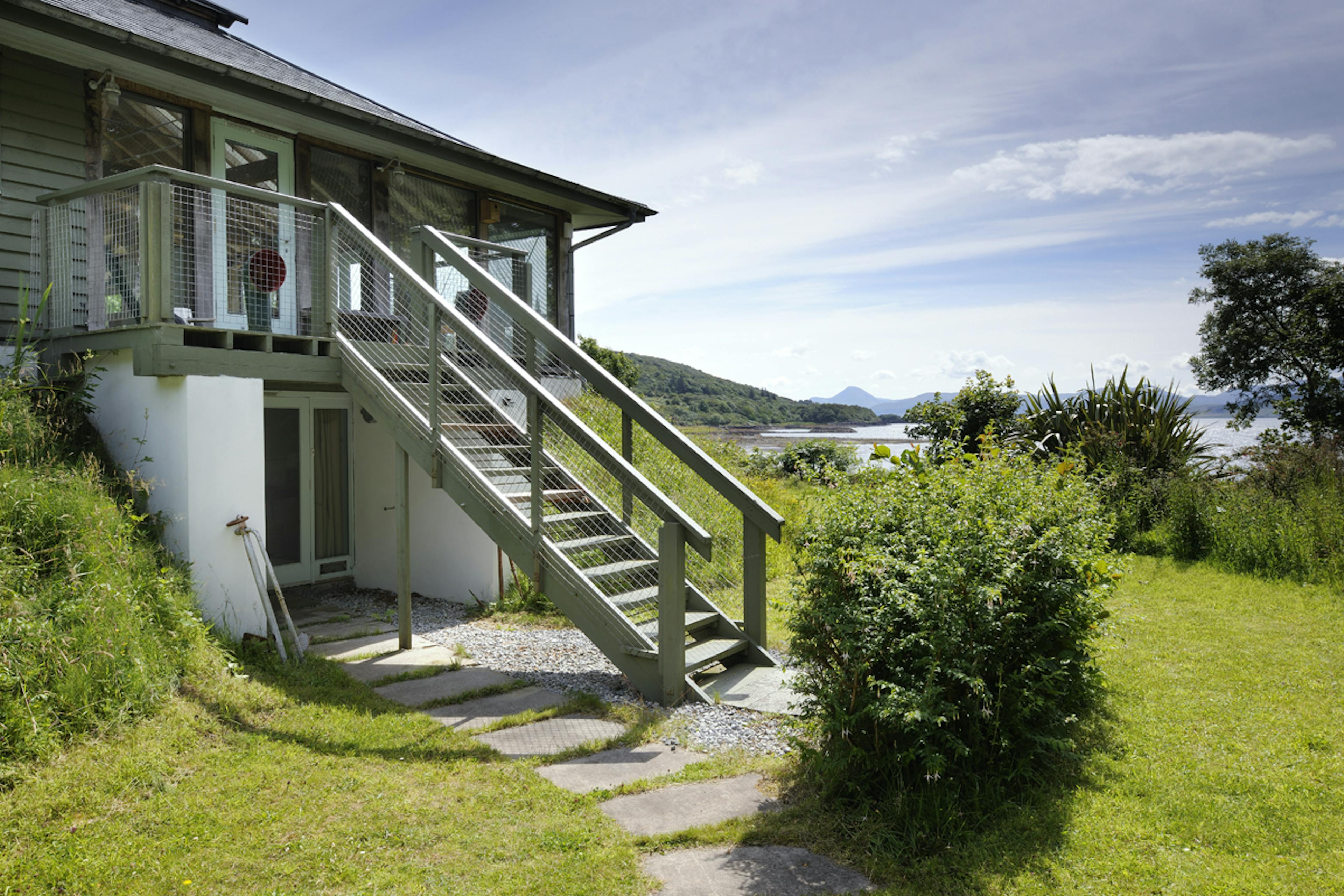 Exterior view of a two-story oak-framed home offering panoramic coastal views