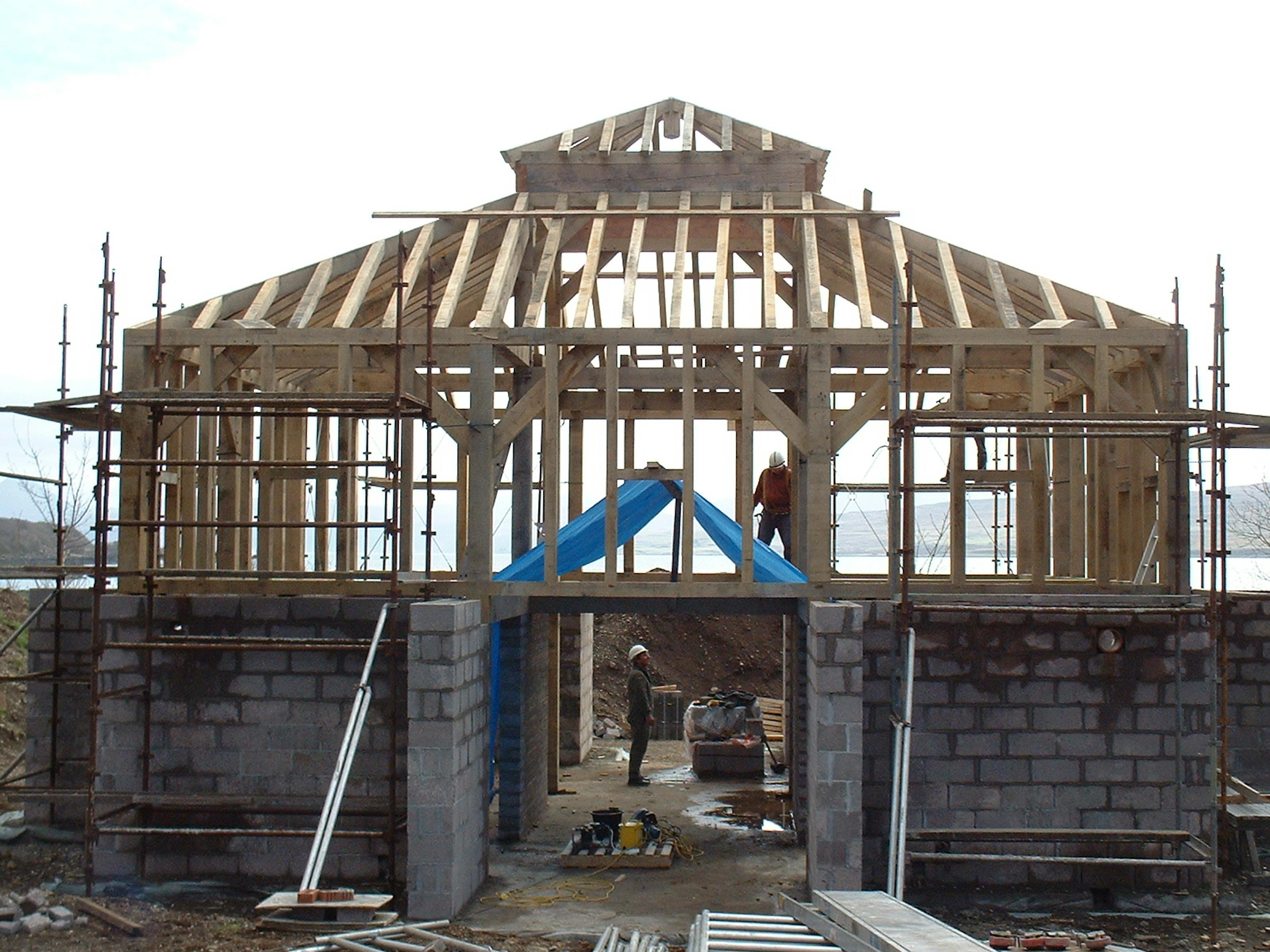 Site installation of a two-story oak-framed home located on the coast