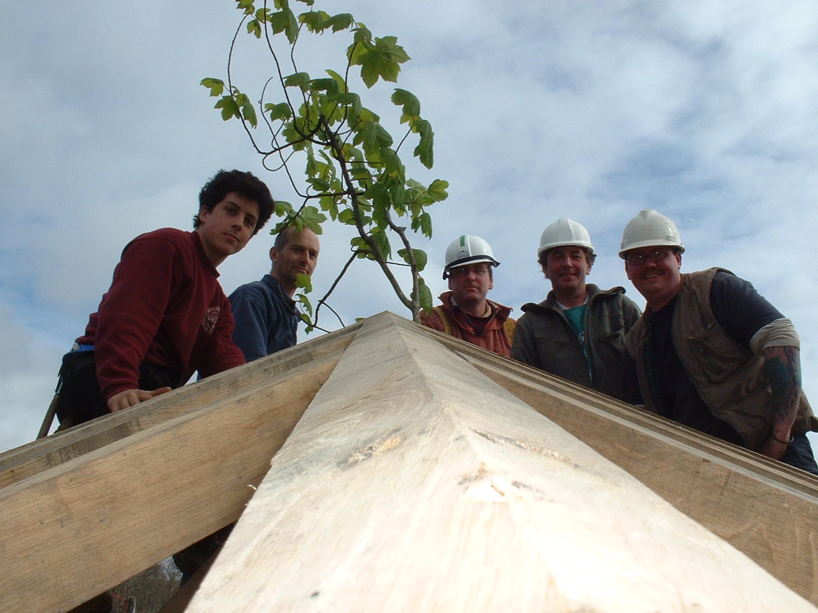 Carpentry team working on a two-story oak-framed home located on the shores of a loch in Scotland