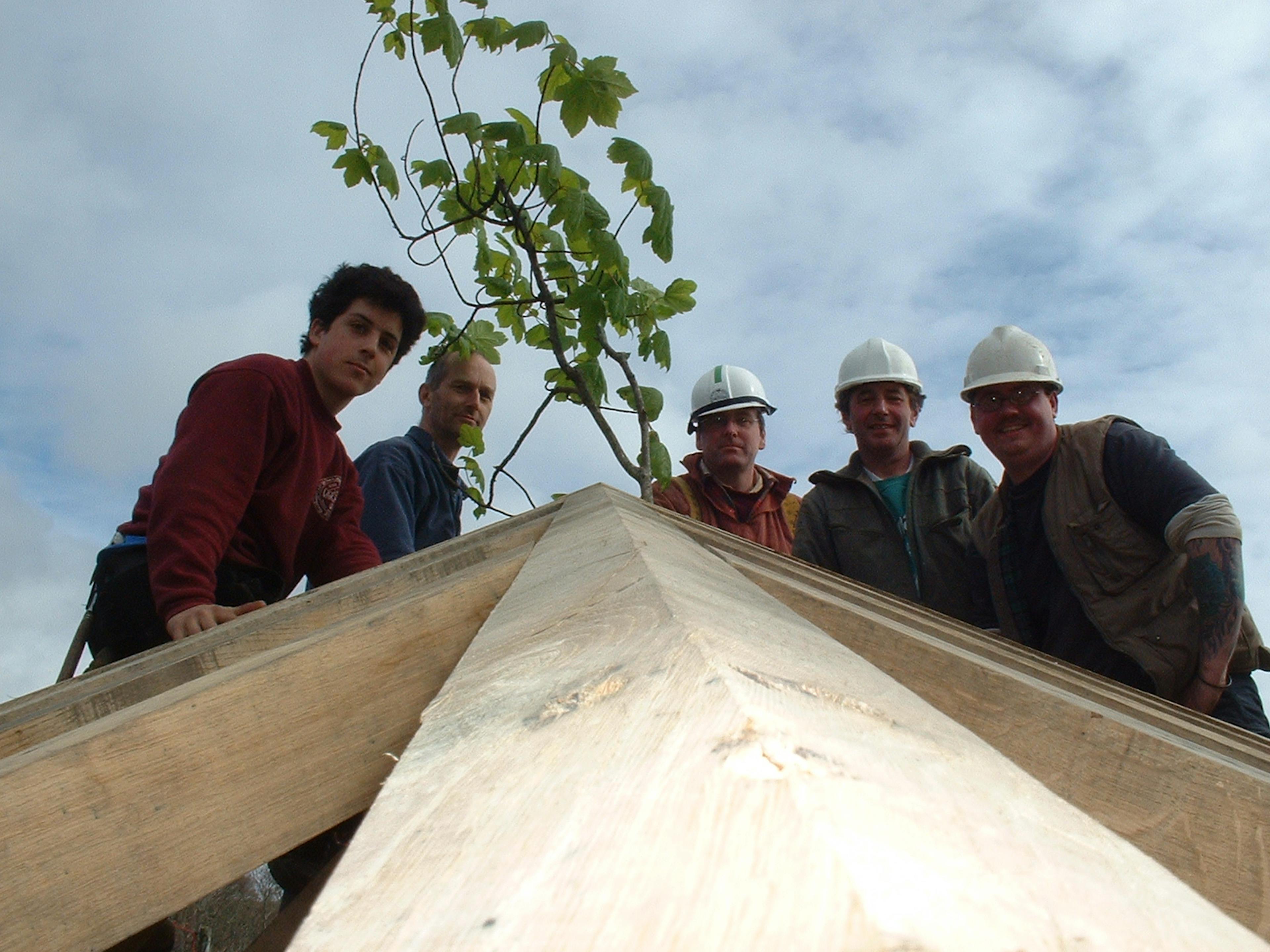 Carpentry team working on a two-story oak-framed home located on the shores of a loch in Scotland