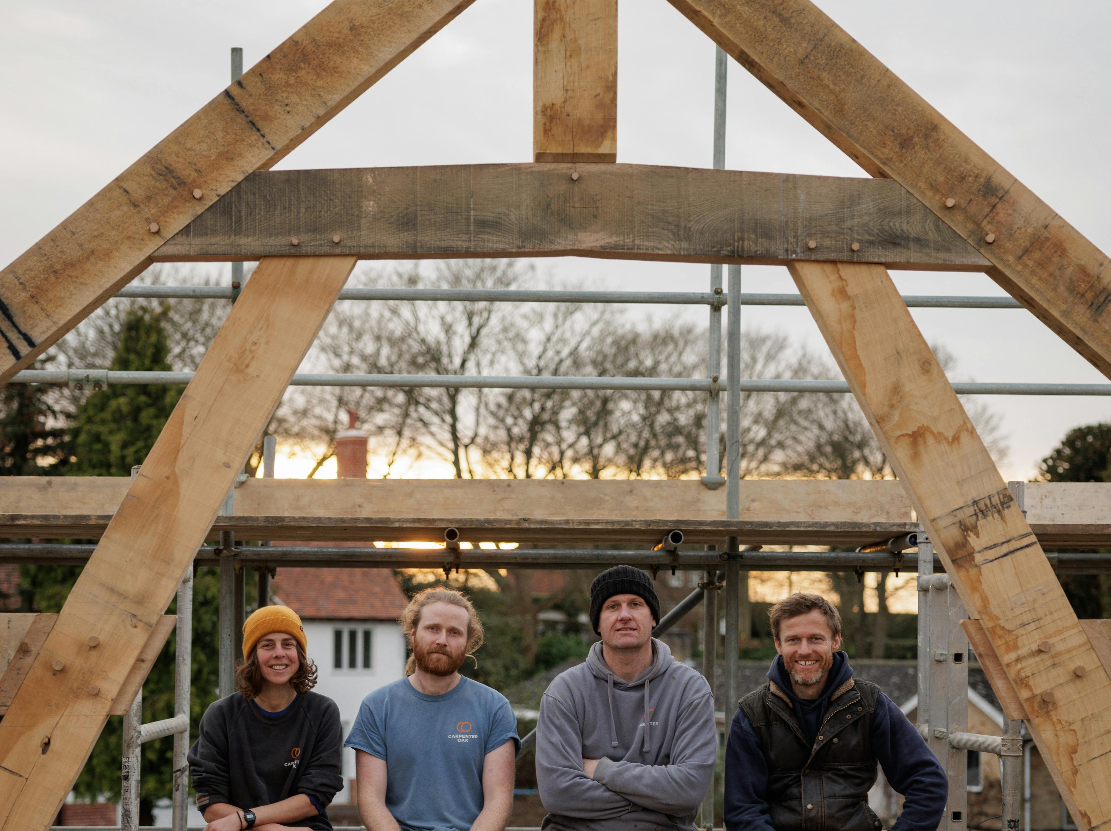 Carpenters completing the installation of an oak-frame family home on-site