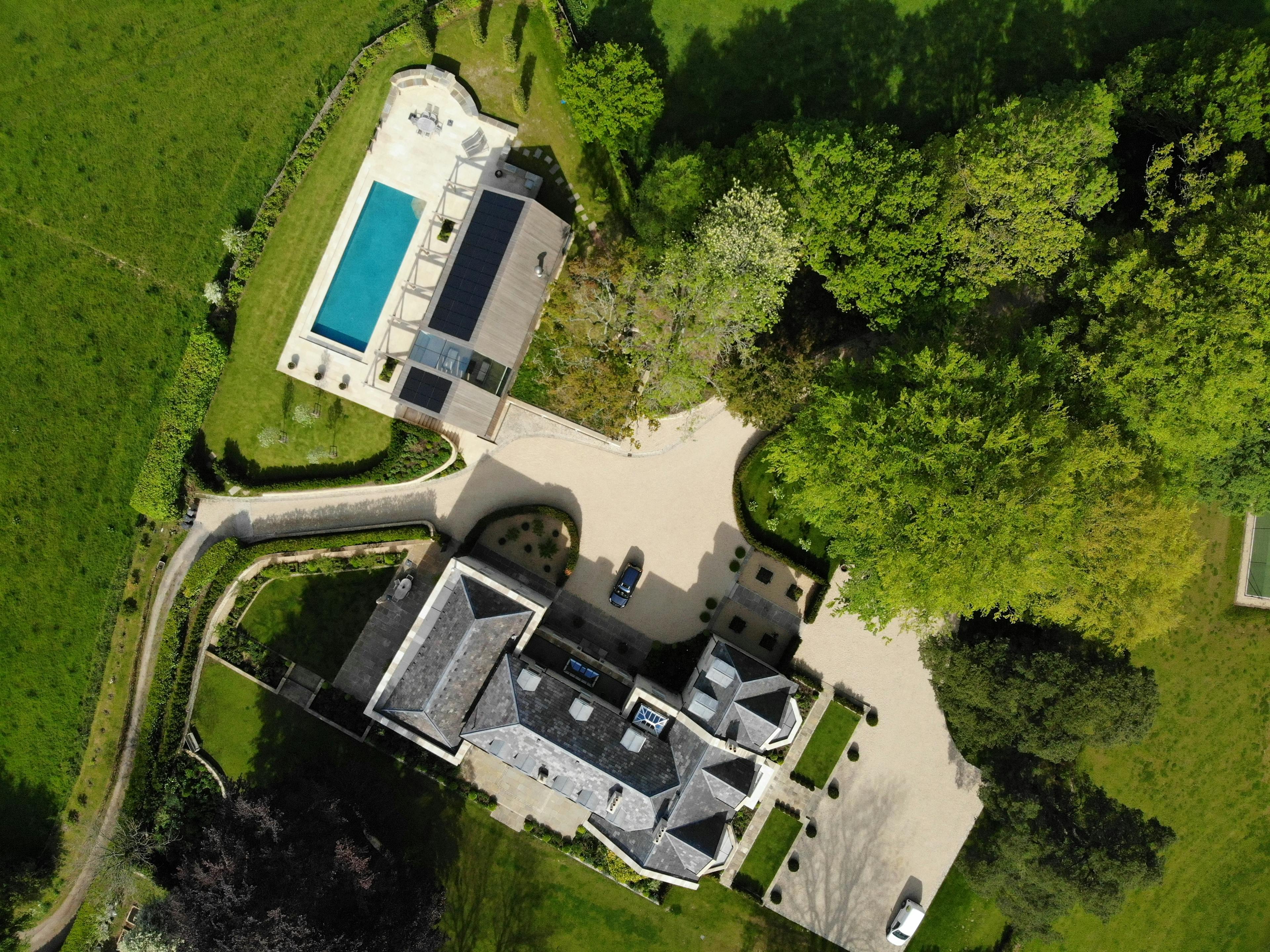 Aerial shot of estate with glulam-framed outbuilding and swimmingpool