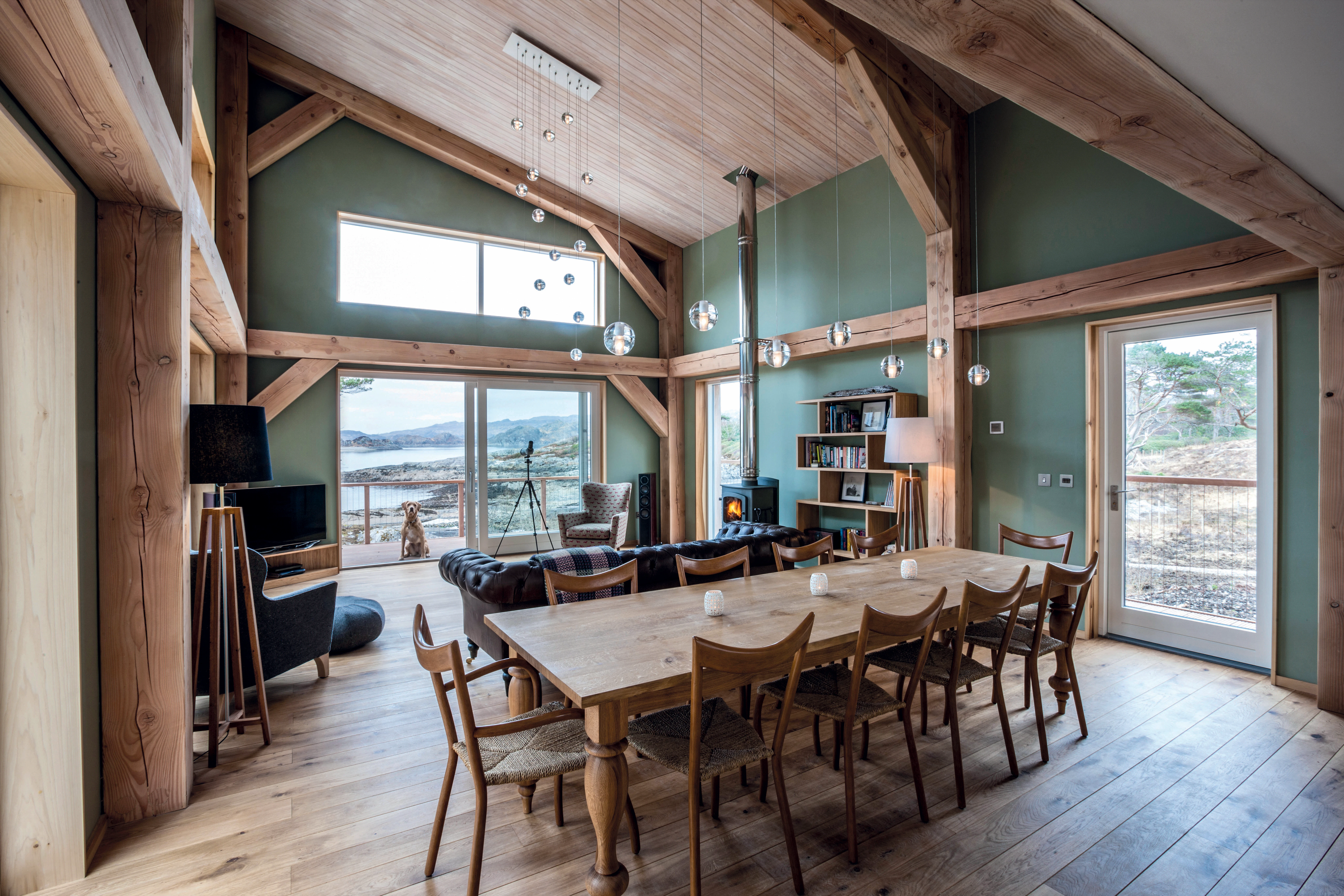 Internal view of an open-plan kitchen and dining room framed in Douglas fir