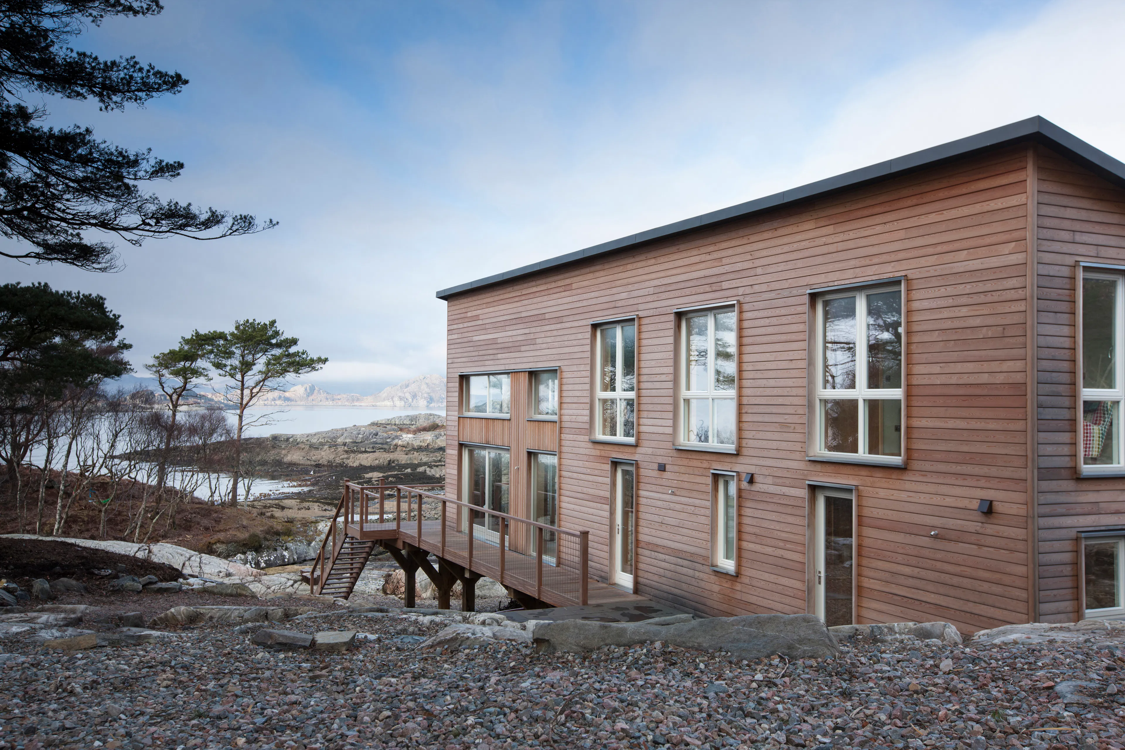 Side view of a Douglas fir-framed family home with timber cladding for a rustic look