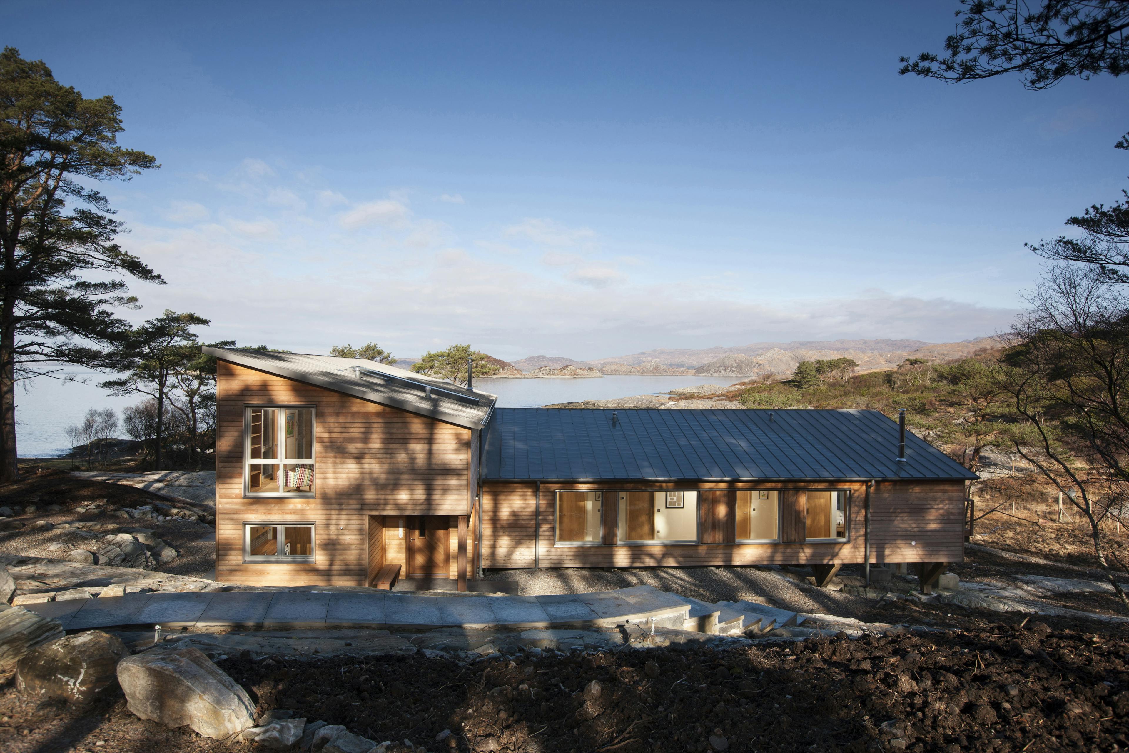 Rear view of a Douglas fir-framed family home with timber cladding for a rustic look