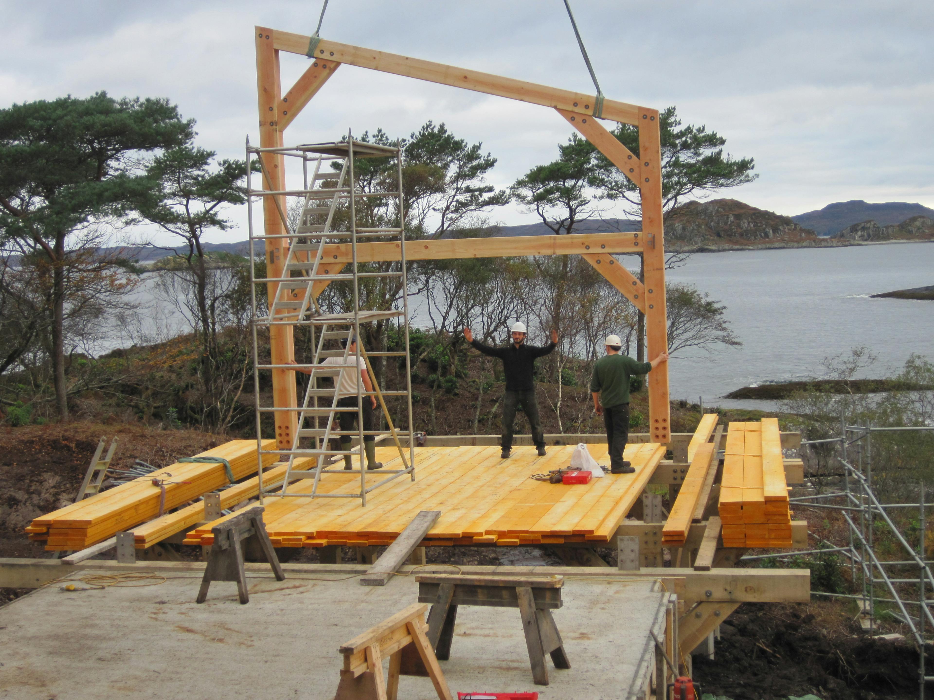 Installing pre-assembled Douglas fir trusses on the shoreline of a loch