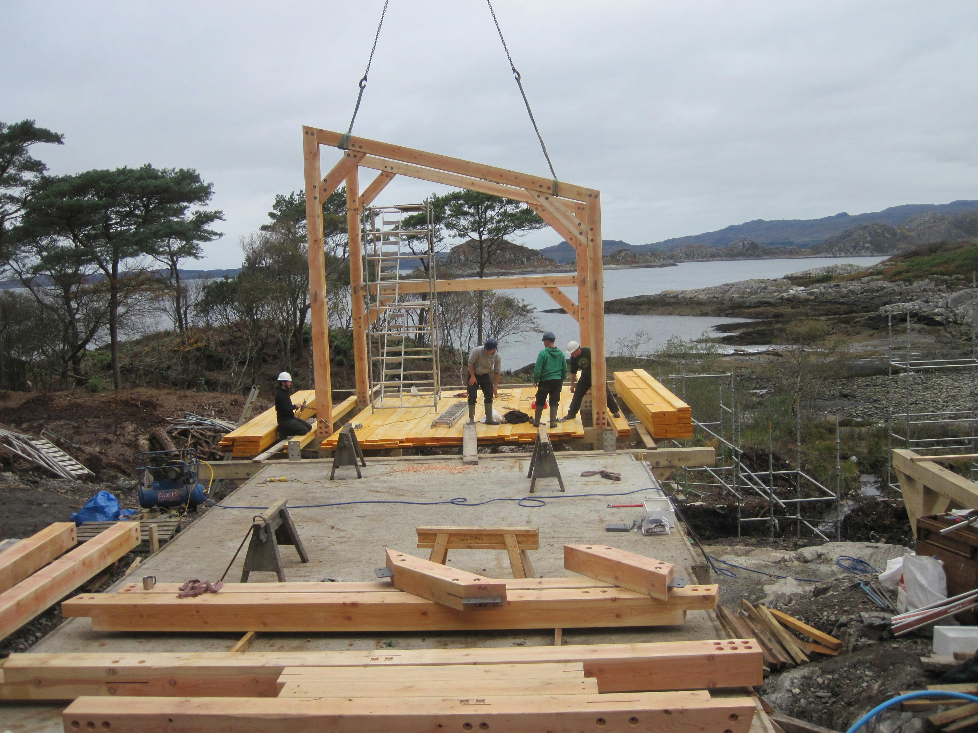 Installing pre-assembled Douglas fir trusses on the shoreline of a loch