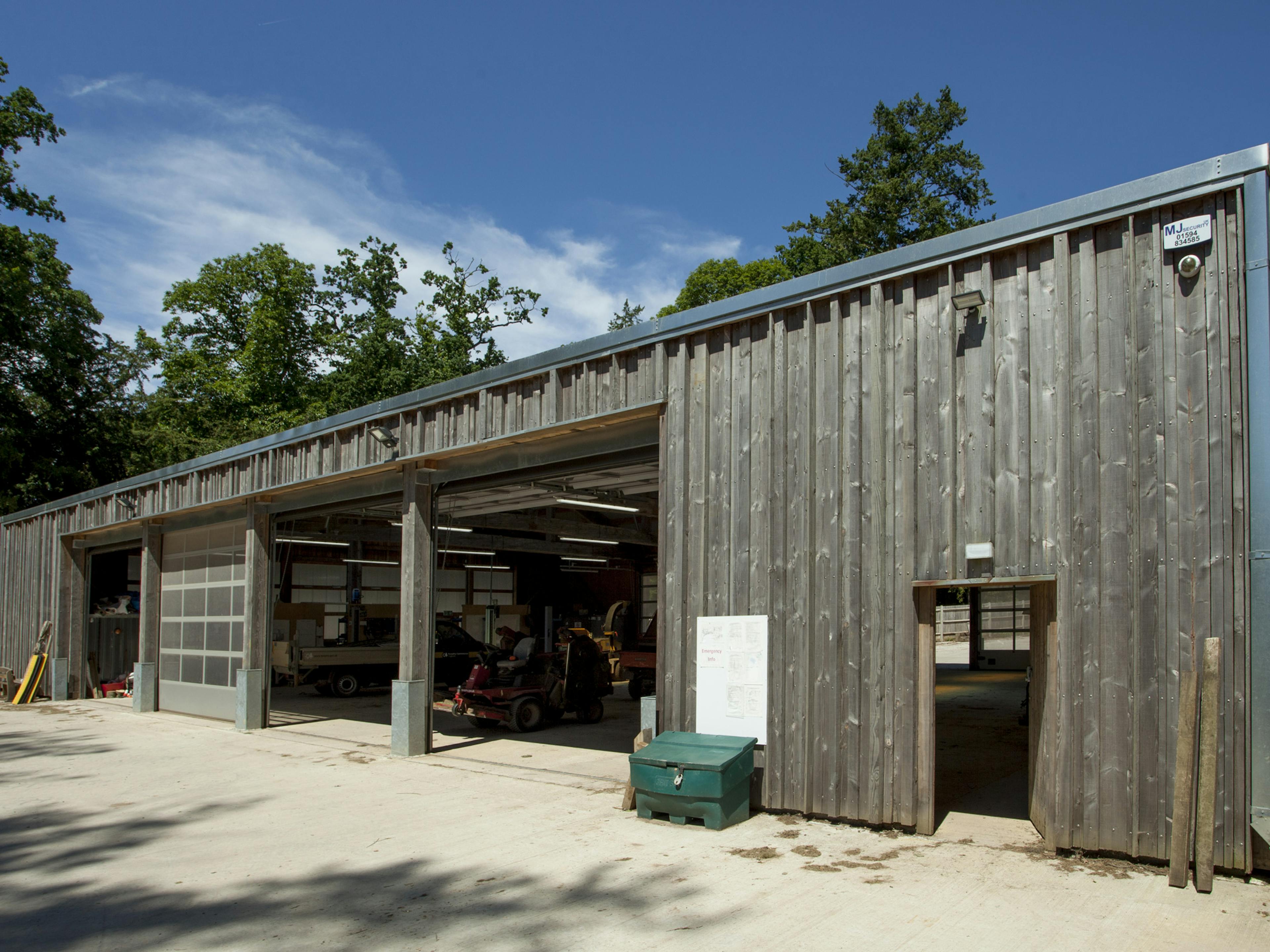 Entrance to a Douglas fir-framed tractor shed with timber cladding