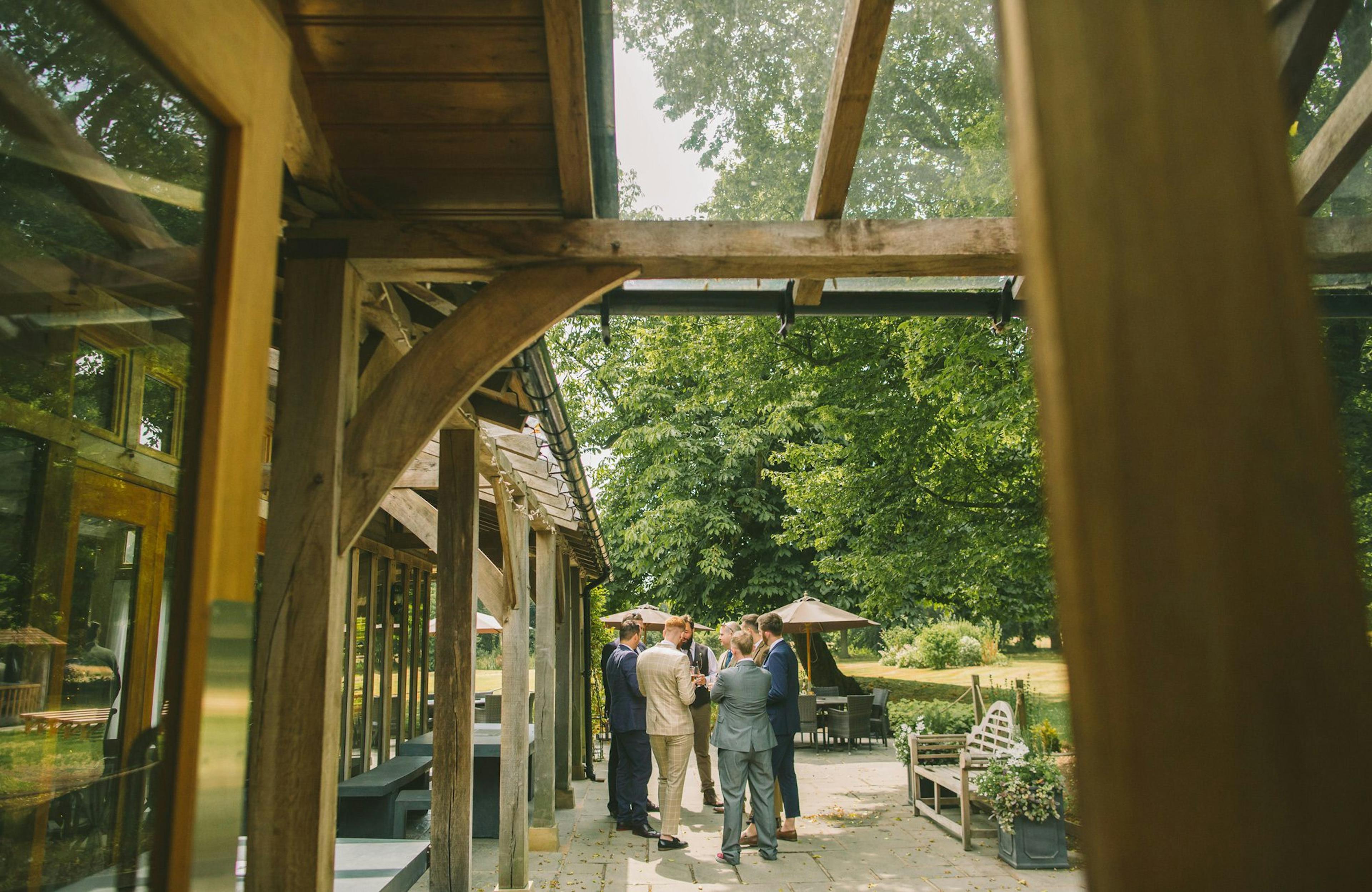 Exterior view of an oak-framed wedding barn with a rustic veranda