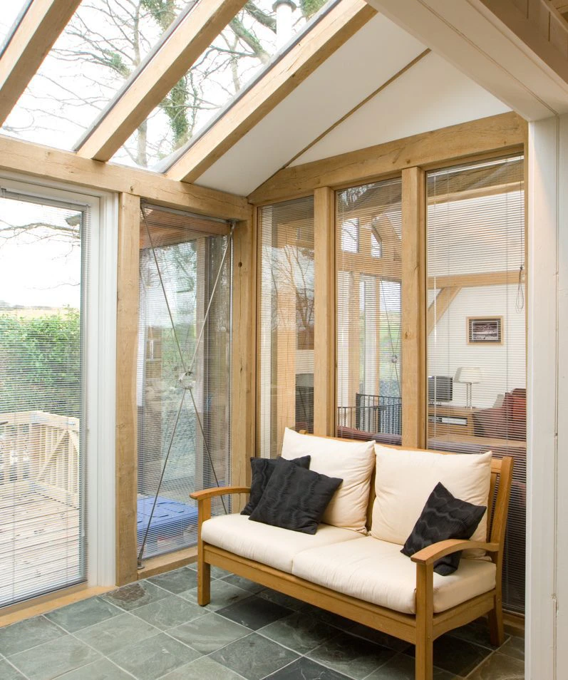 Interior view of an oak-framed extension featuring large glazed panels