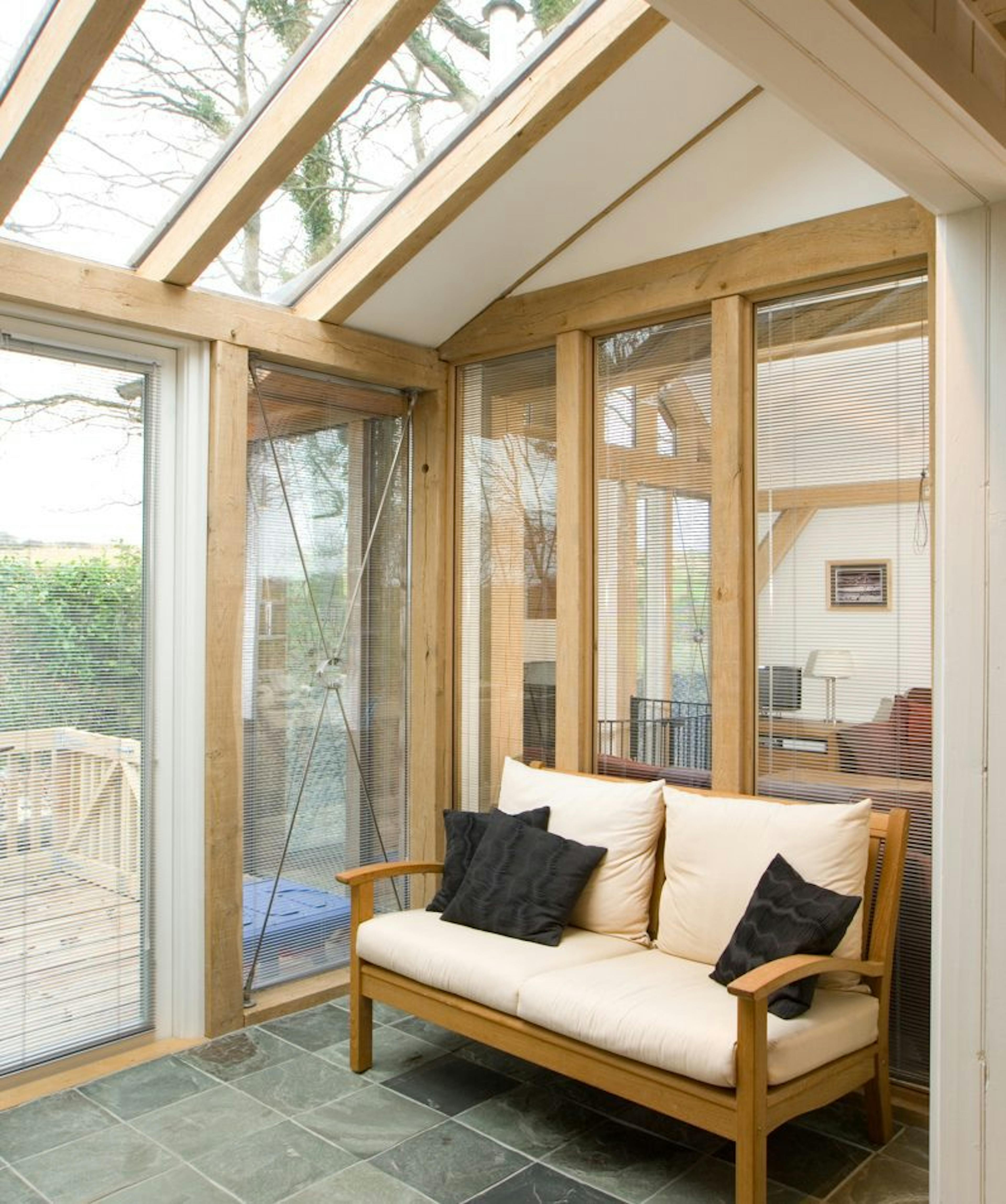 Interior view of an oak-framed extension featuring large glazed panels