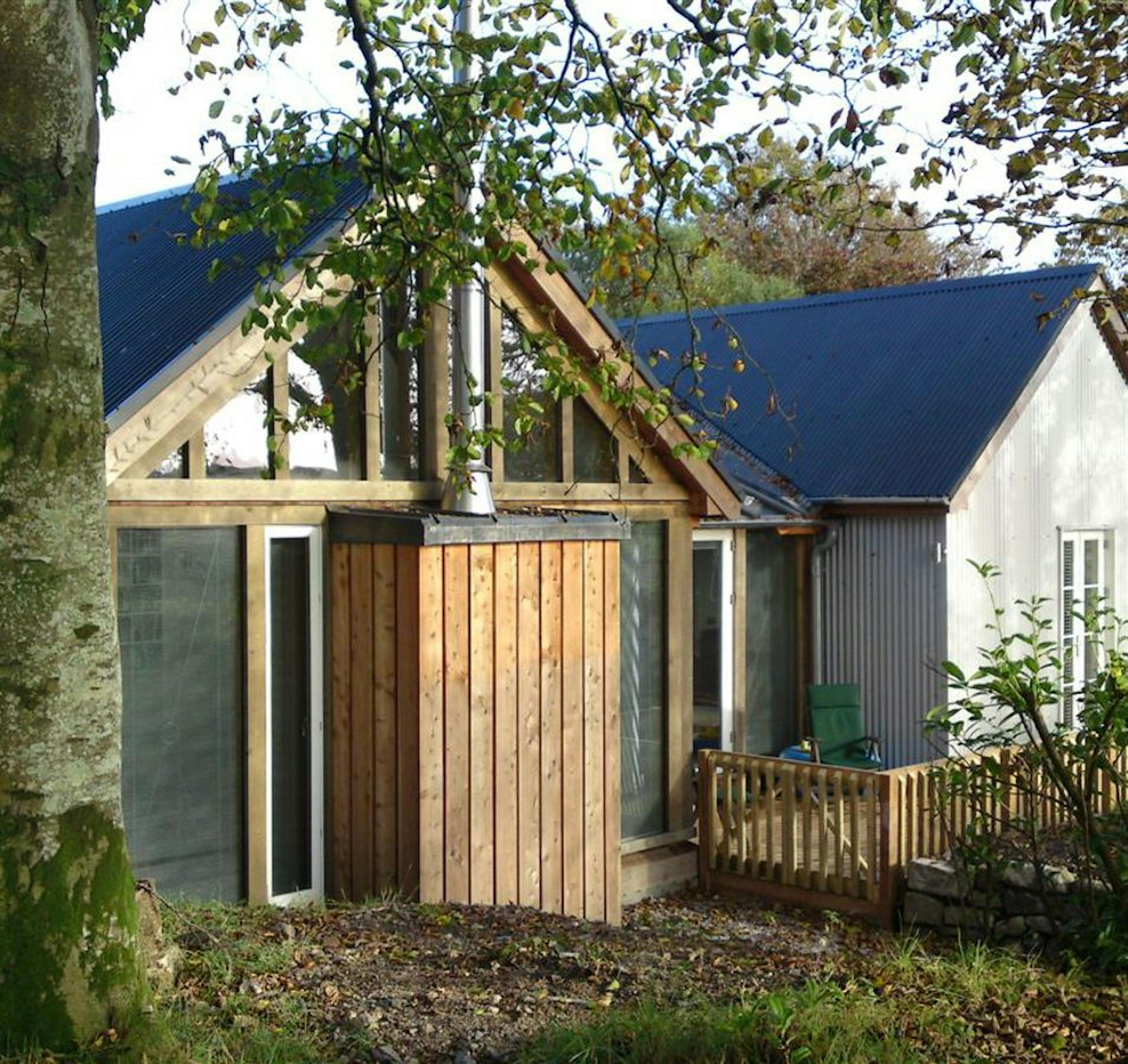 Exterior view of an oak-framed extension with a central wood burner