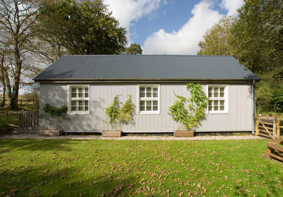 External view of an oak-framed extension added to the side of a Victorian-style home