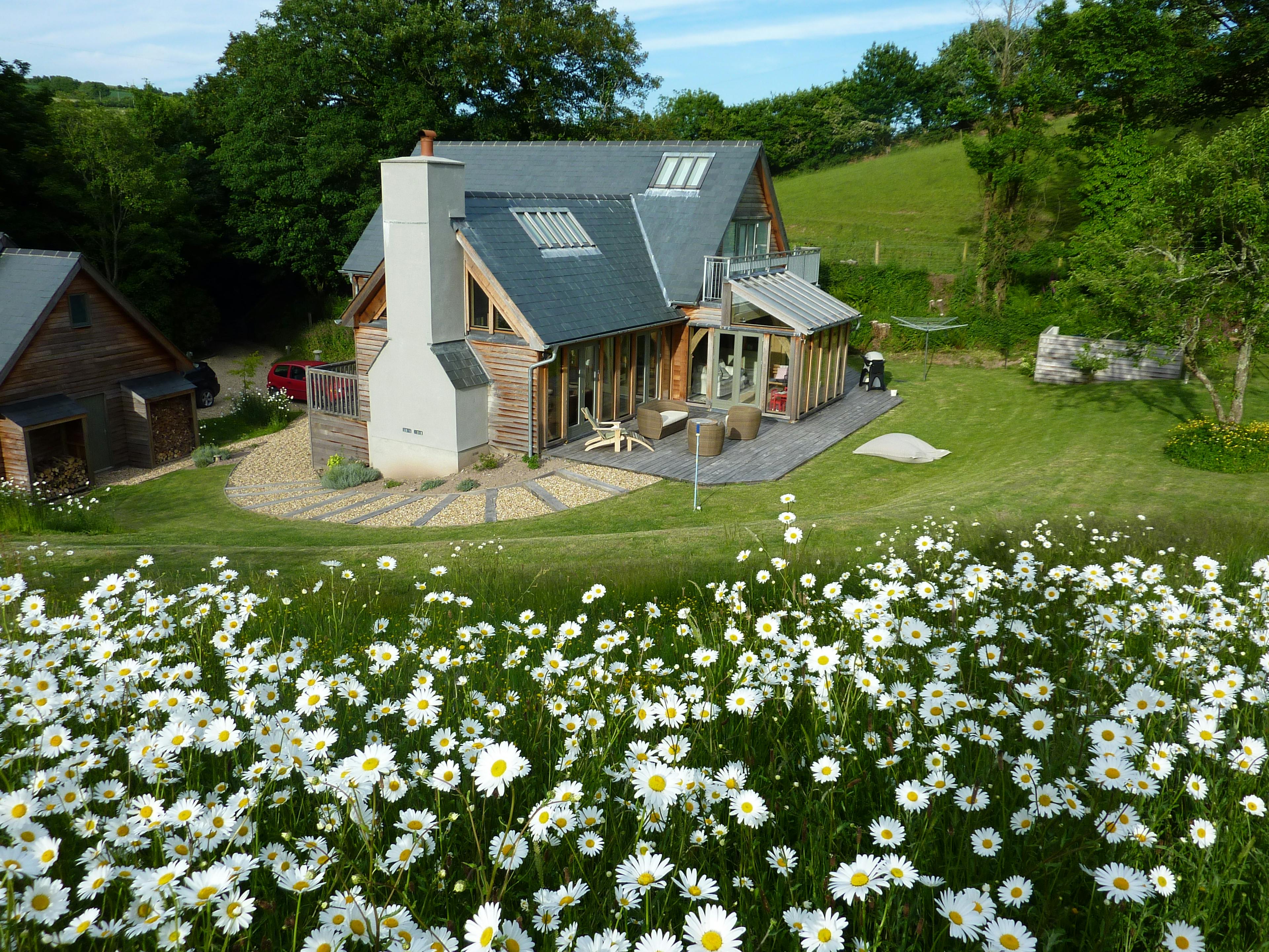 Exterior view of a one-and-a-half-storey oak-framed family home in the countryside