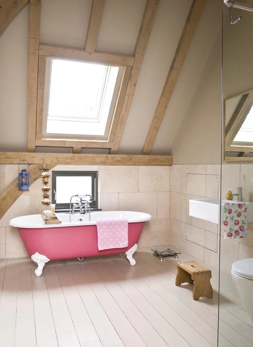 Interior view of an oak-framed bathroom with a roof light that allows natural light to flood the space