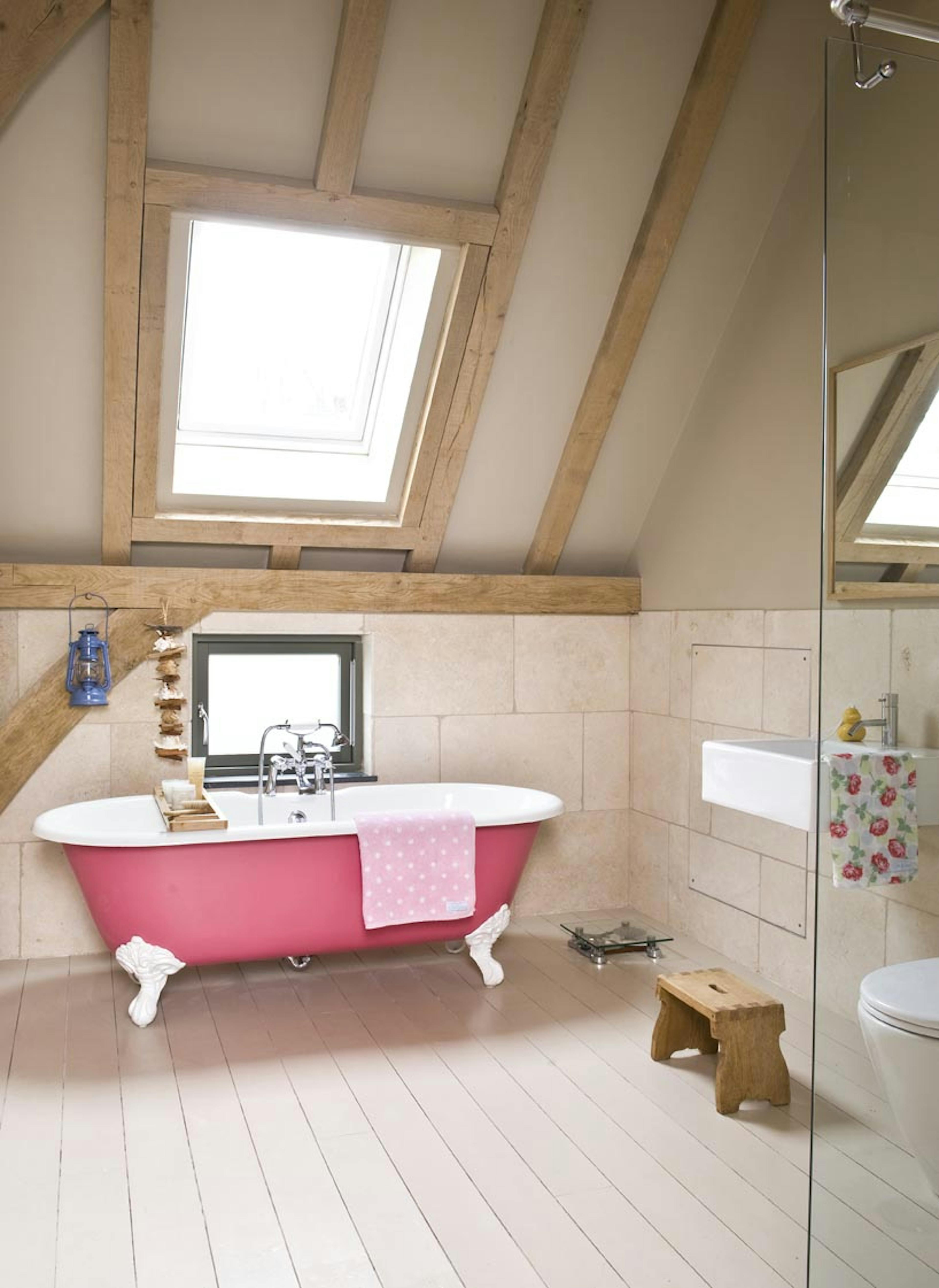 Interior view of an oak-framed bathroom with a roof light that allows natural light to flood the space