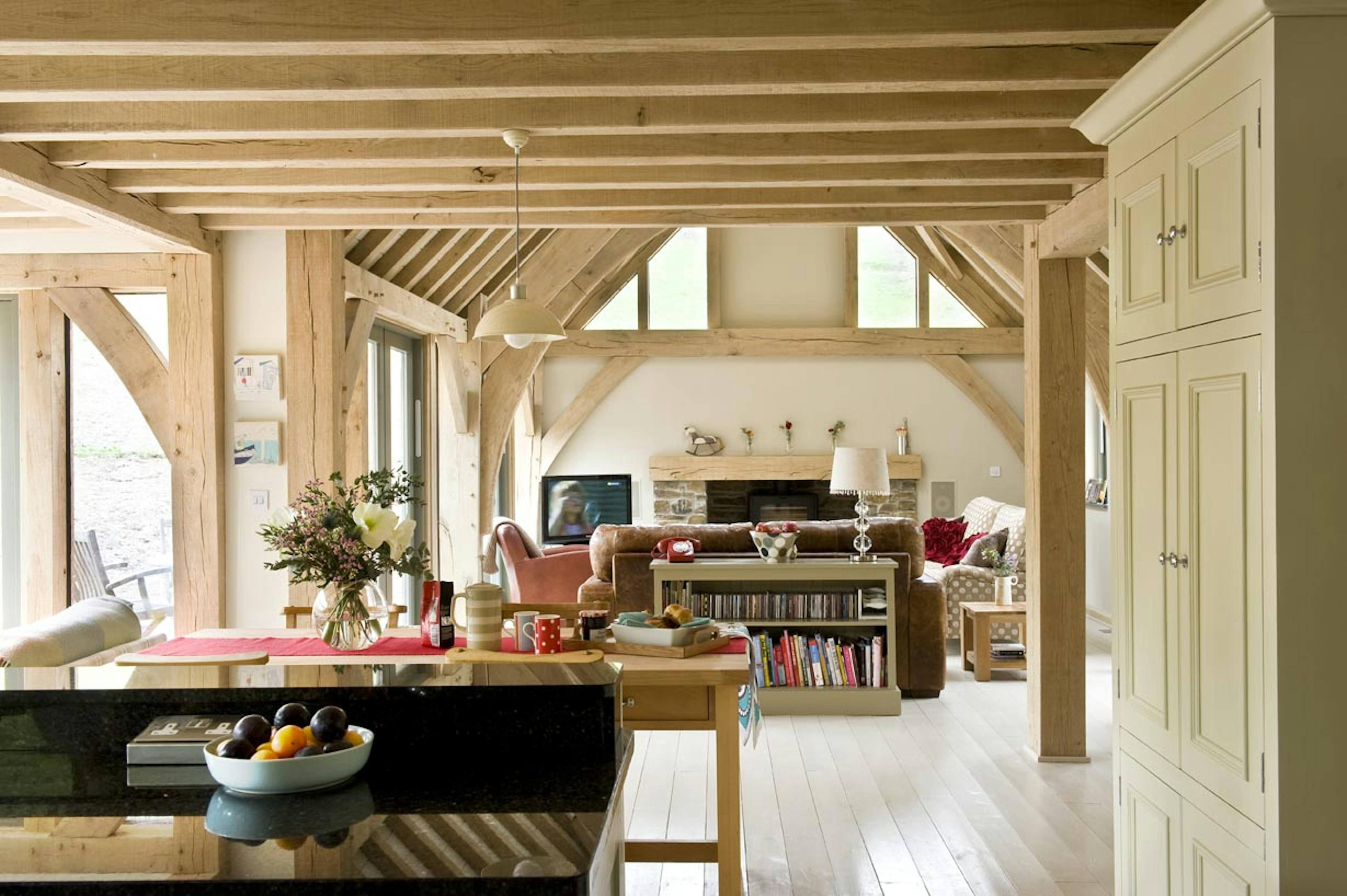 Interior view of an open-plan living space with vaulted ceilings above the lounge area