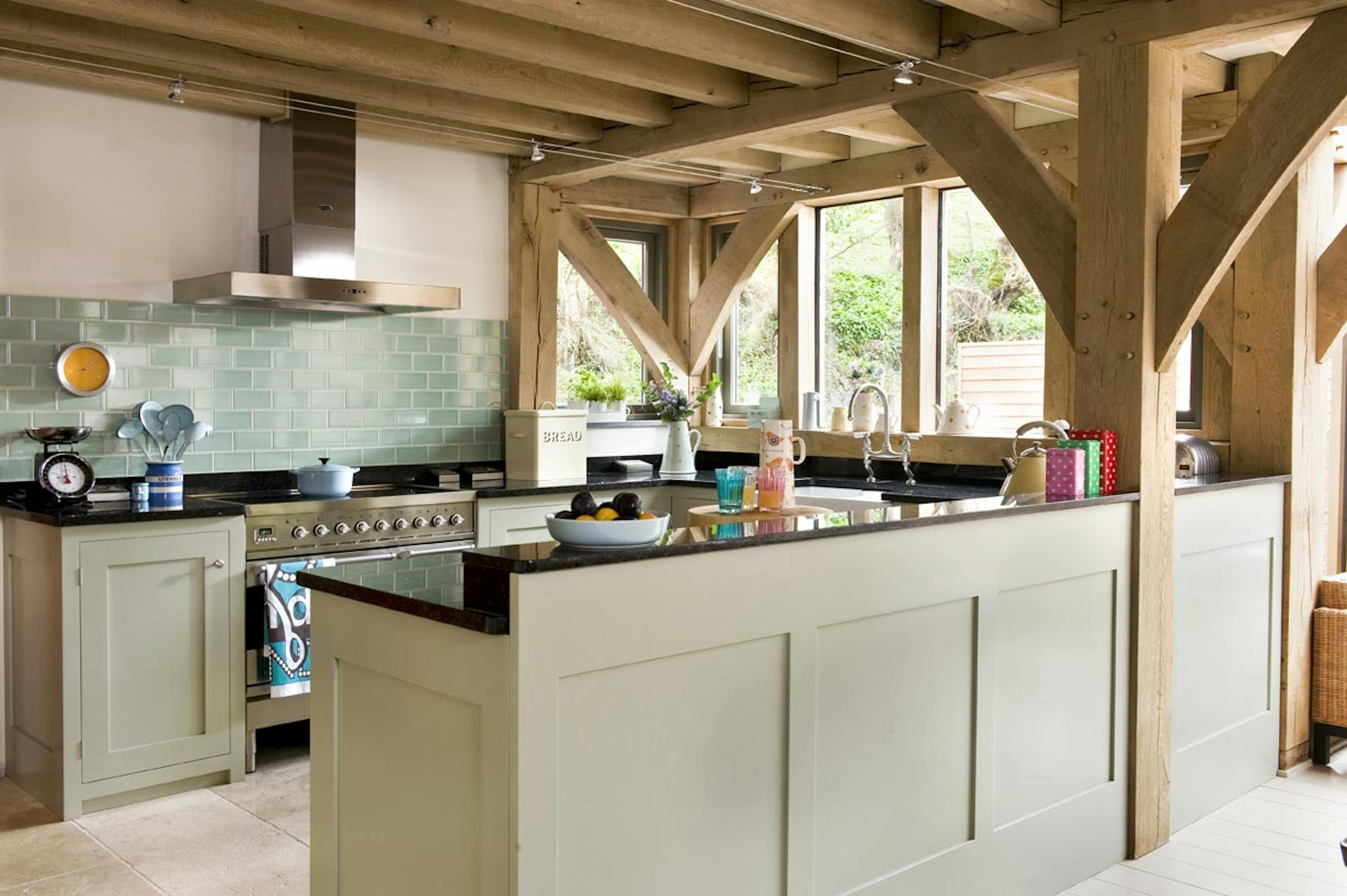 Interior view of an open-plan living space with a farmhouse-style kitchen