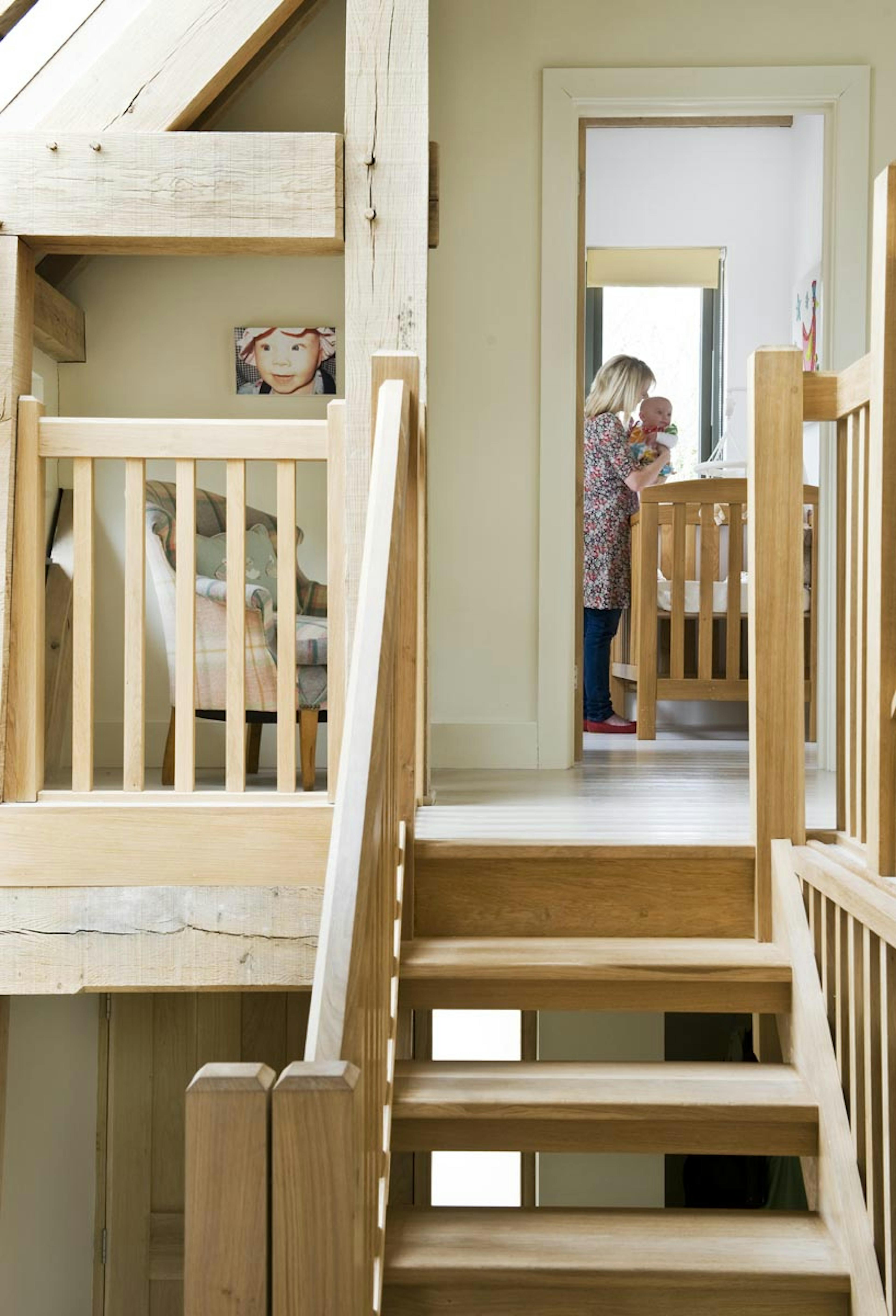 Interior view of an oak-framed family home with an oak staircase leading to a nursery