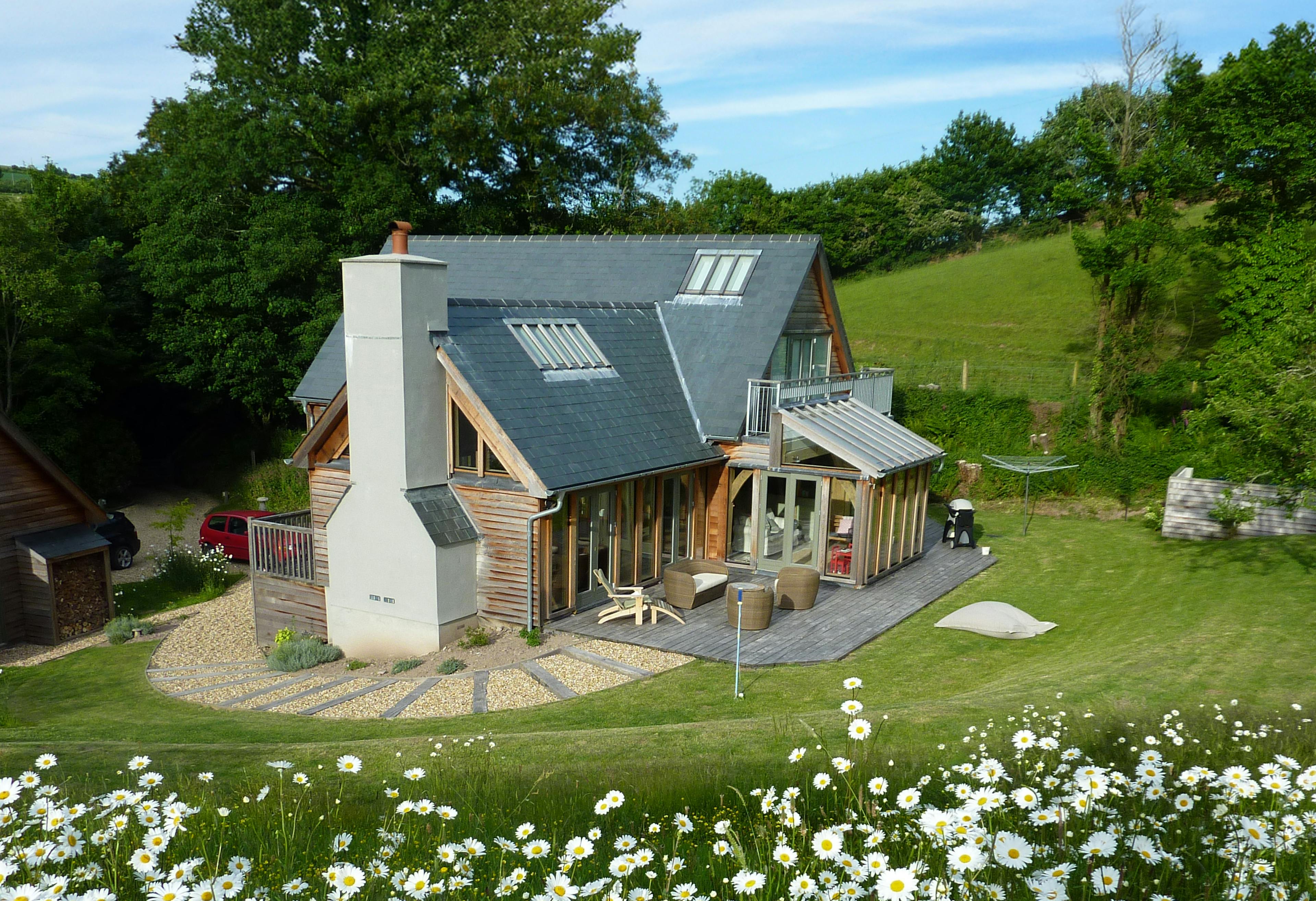Exterior view of a one-and-a-half-storey oak-framed family home near the coast