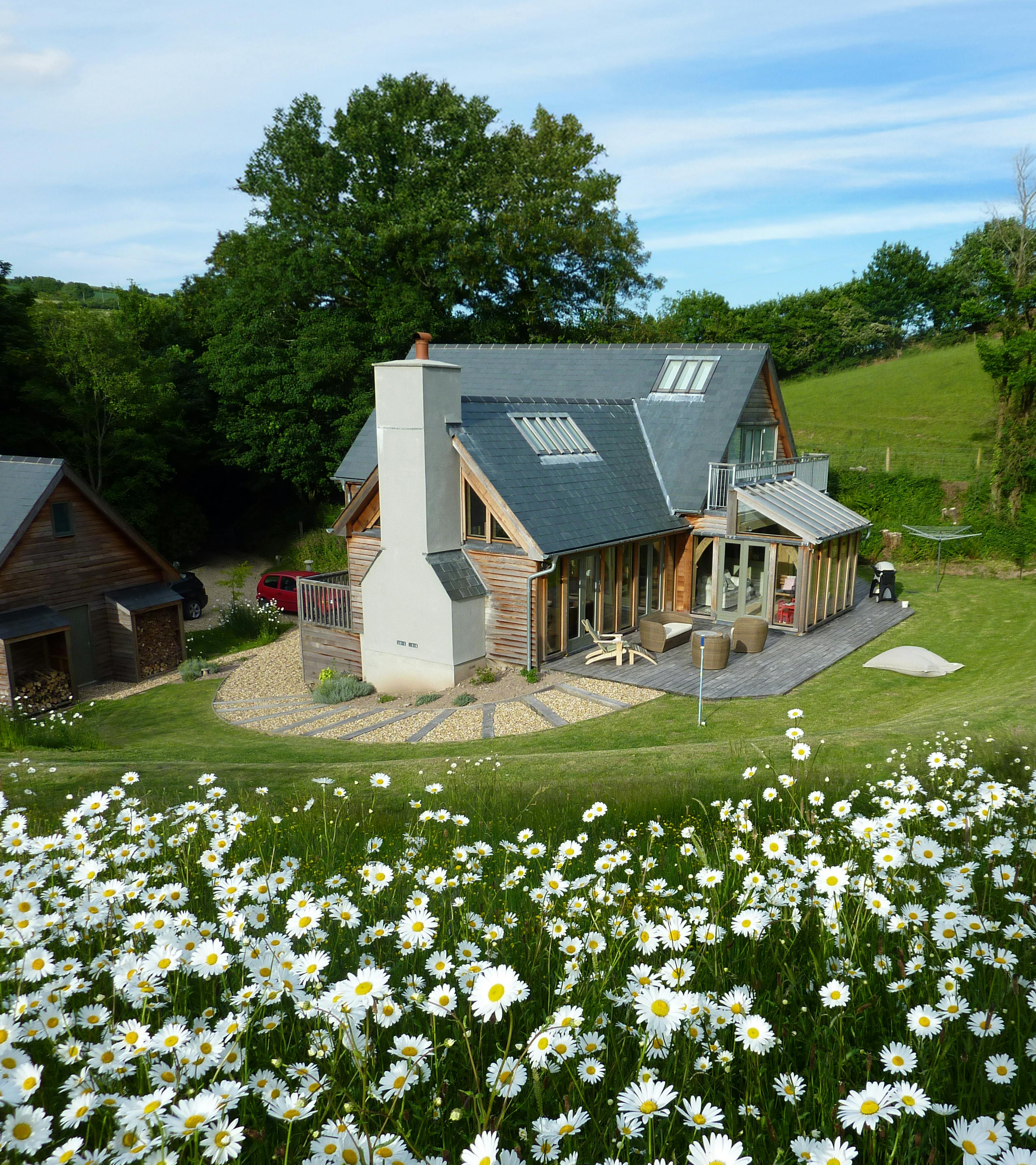 Exterior view of a one-and-a-half-storey oak-framed family home near the coast