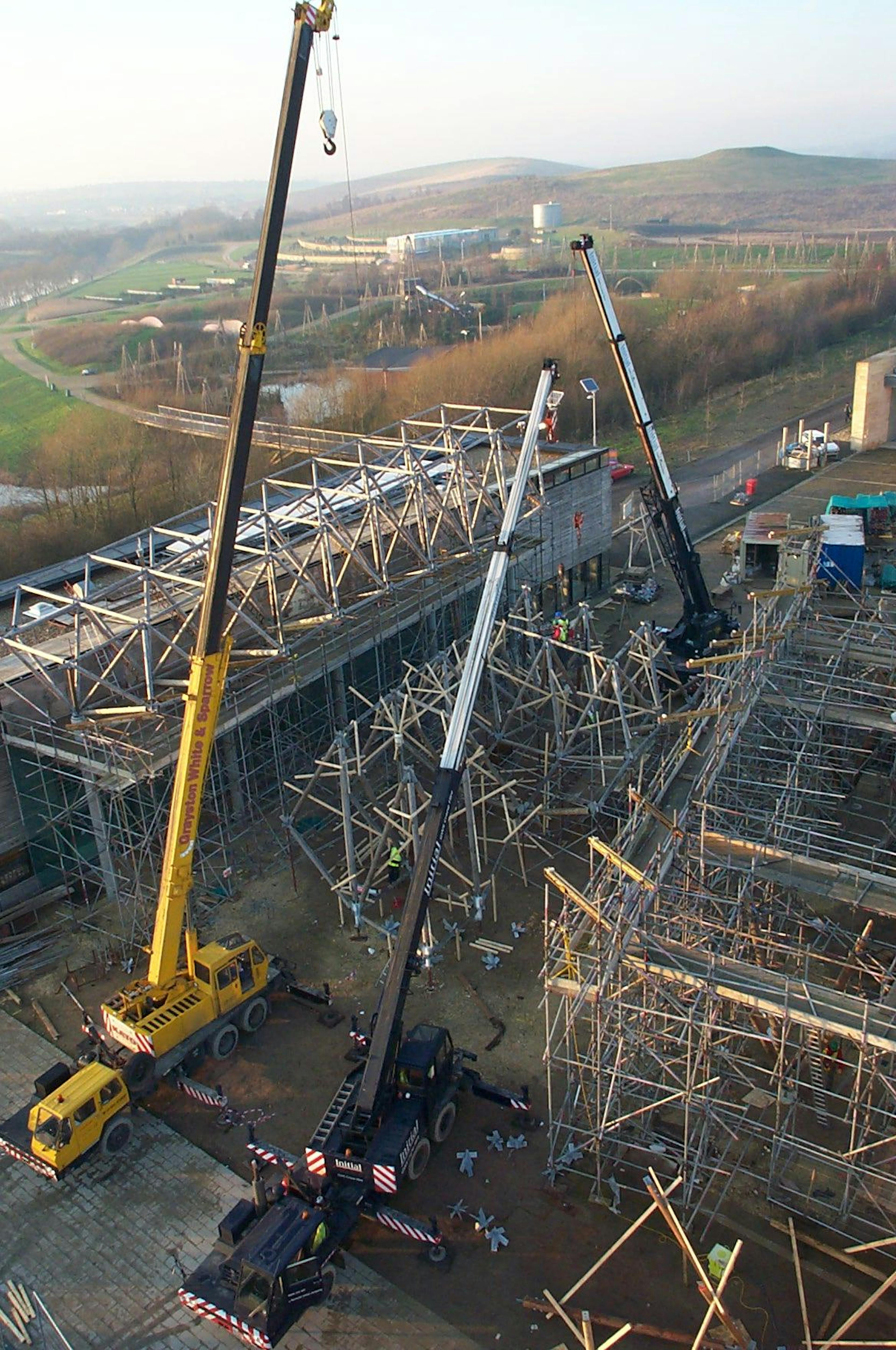 Site installation of an abstract, geometrically complex canopy constructed from Larch