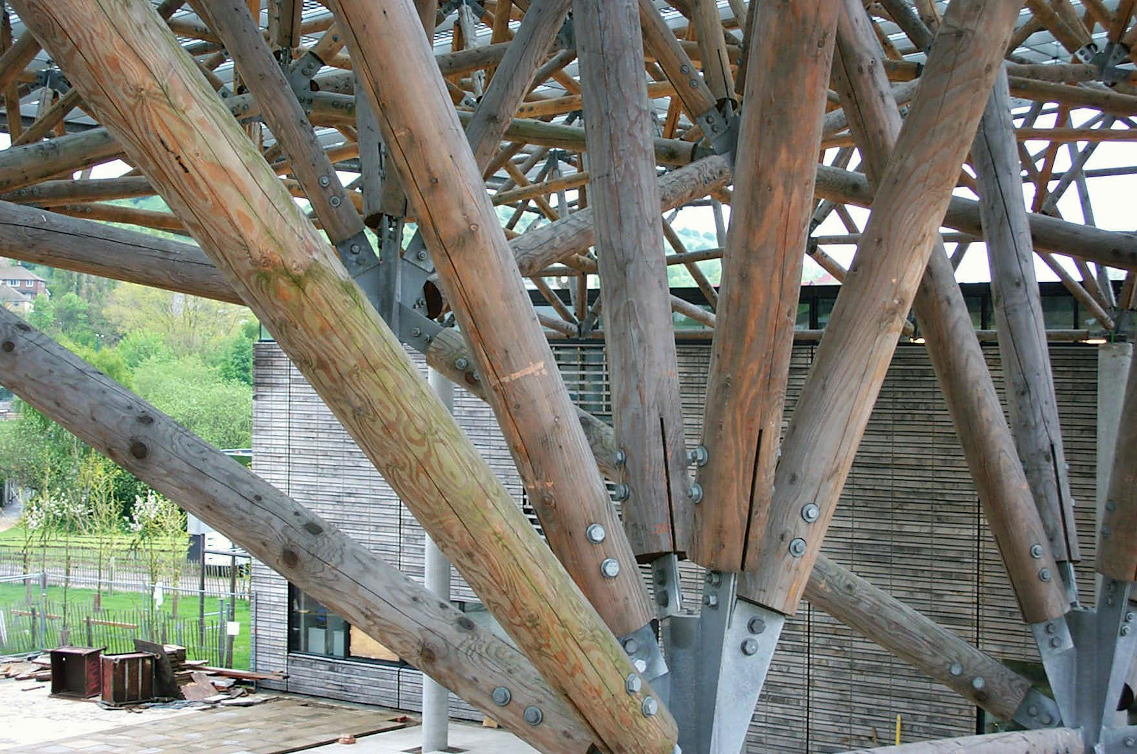 Detail of an abstract, geometrically complex canopy with timber and steel fixings, constructed from Larch