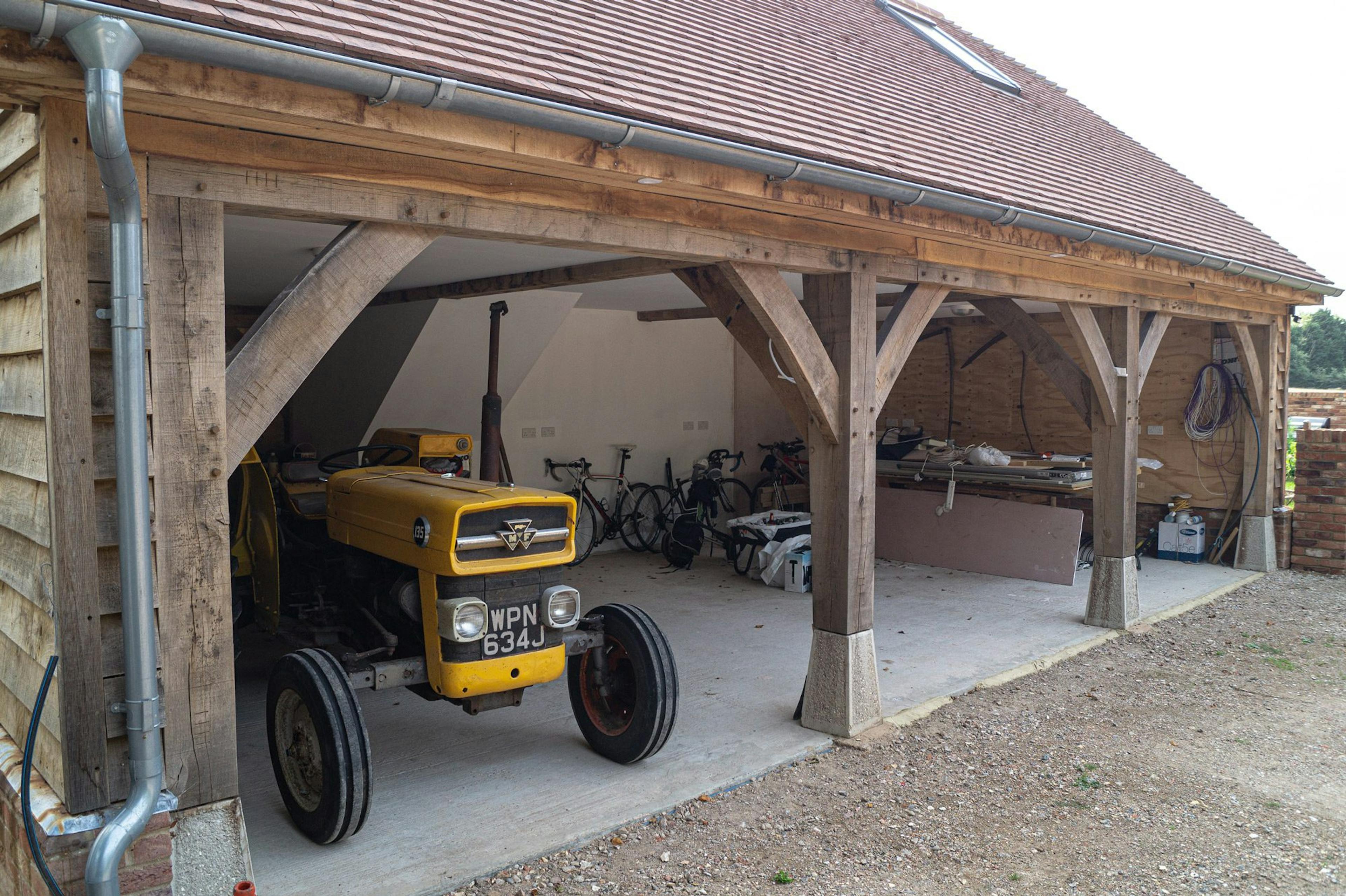 Oak-framed one-and-a-half-storey garage with living space above and open, practical space below