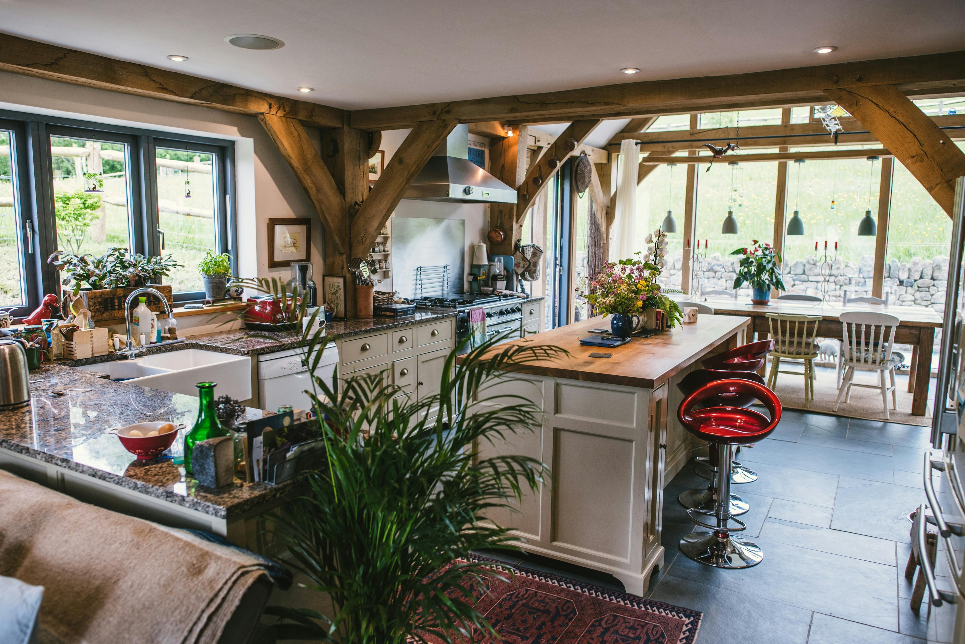 Interior view of an open-plan, oak-framed, two-storey family home with a farmhouse-style kitchen