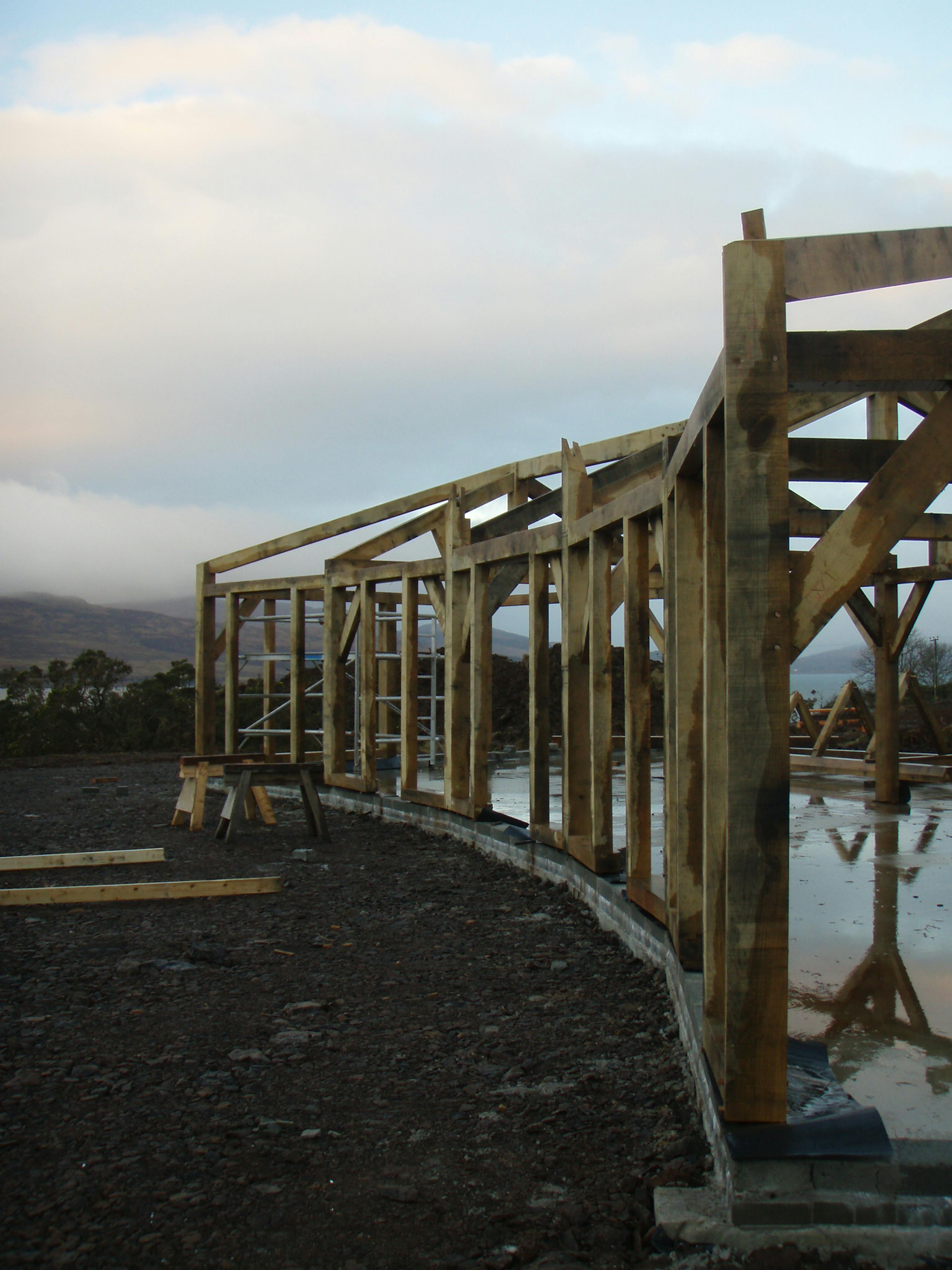 Site installation of a unique, curved oak-framed family home