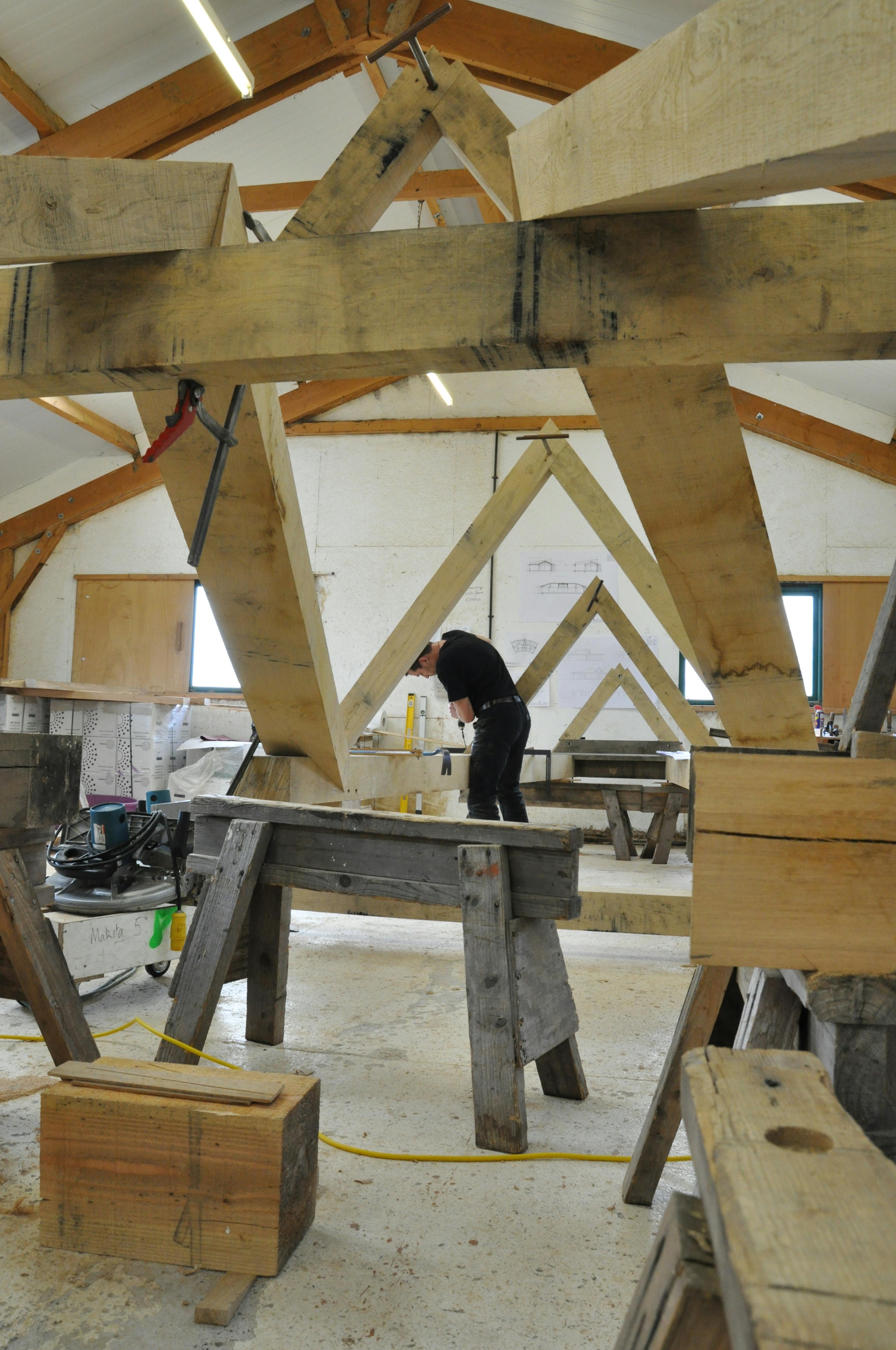Pre-assembled roof lantern for a curved oak-framed family home being built in the workshop by carpenters