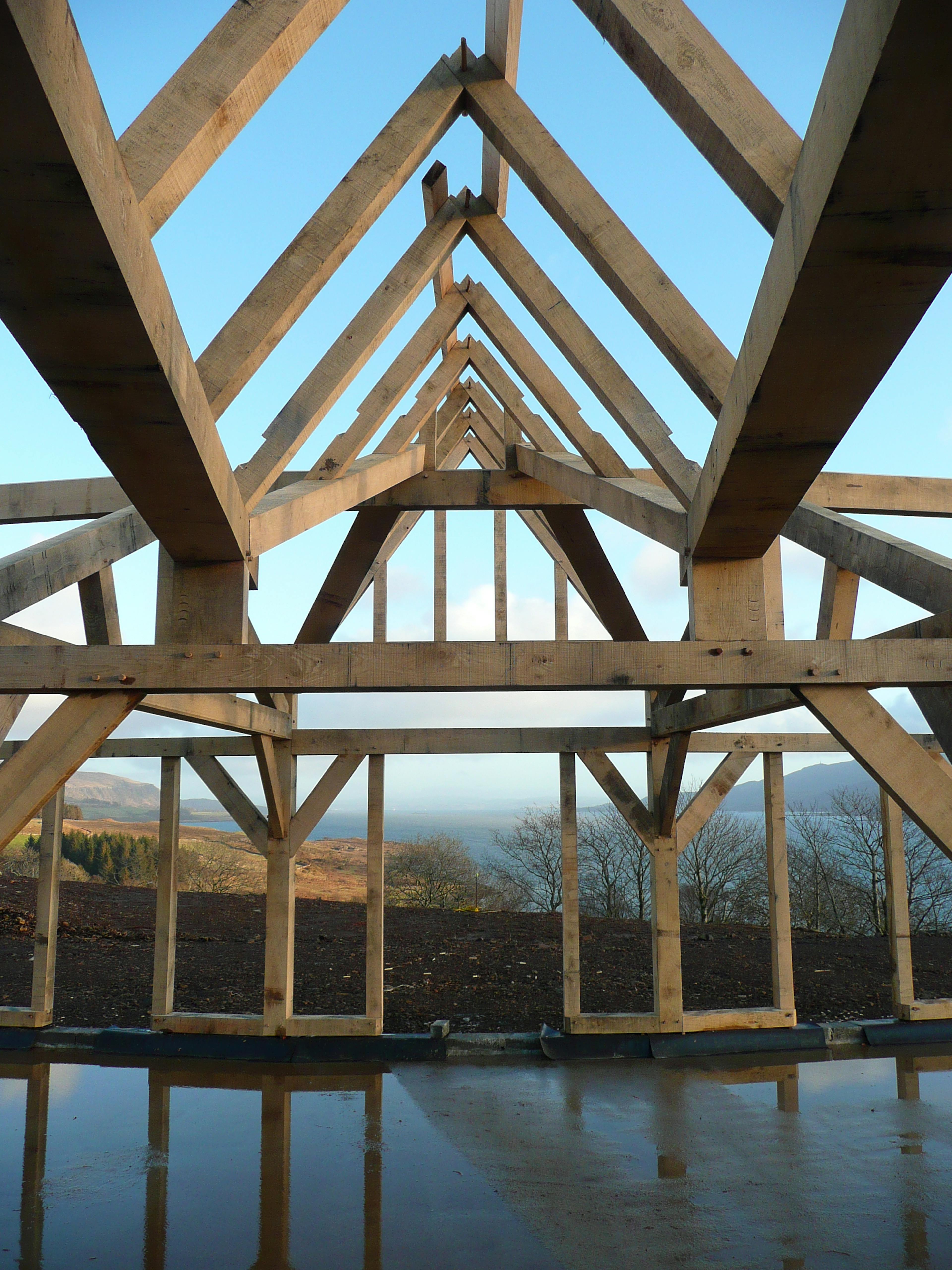 Interior view of a curved oak-framed family home during on-site installation
