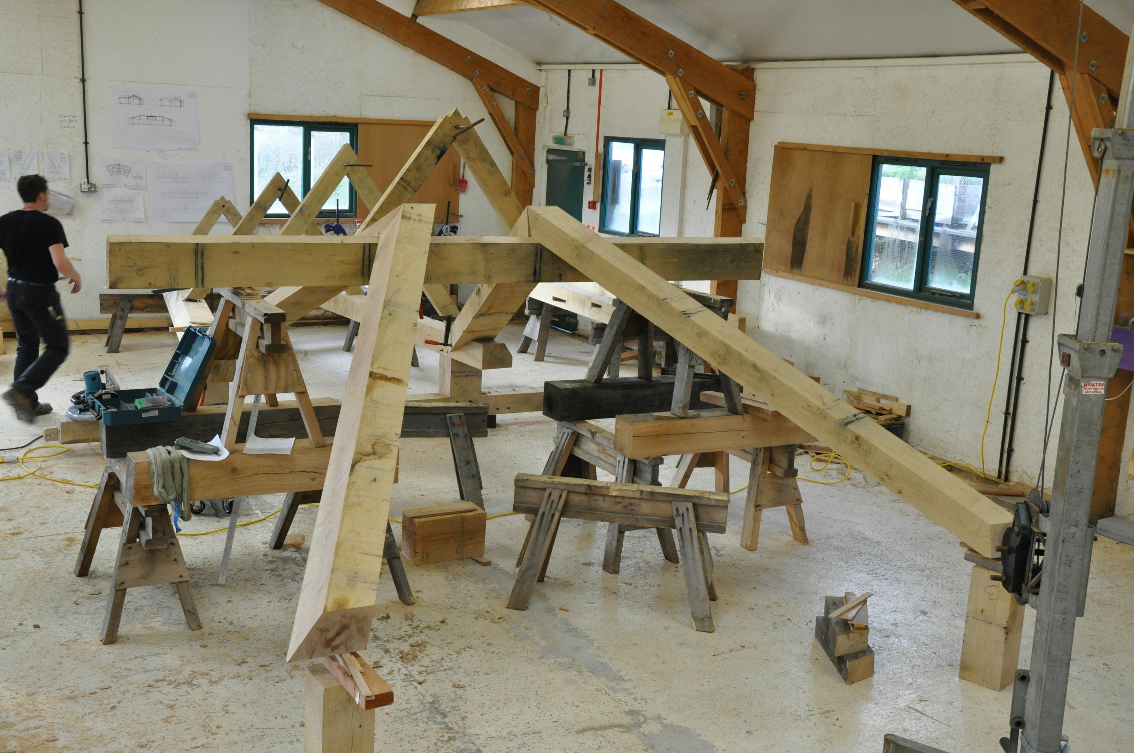 Pre-assembled section of a curved oak-framed family home being built in the workshop