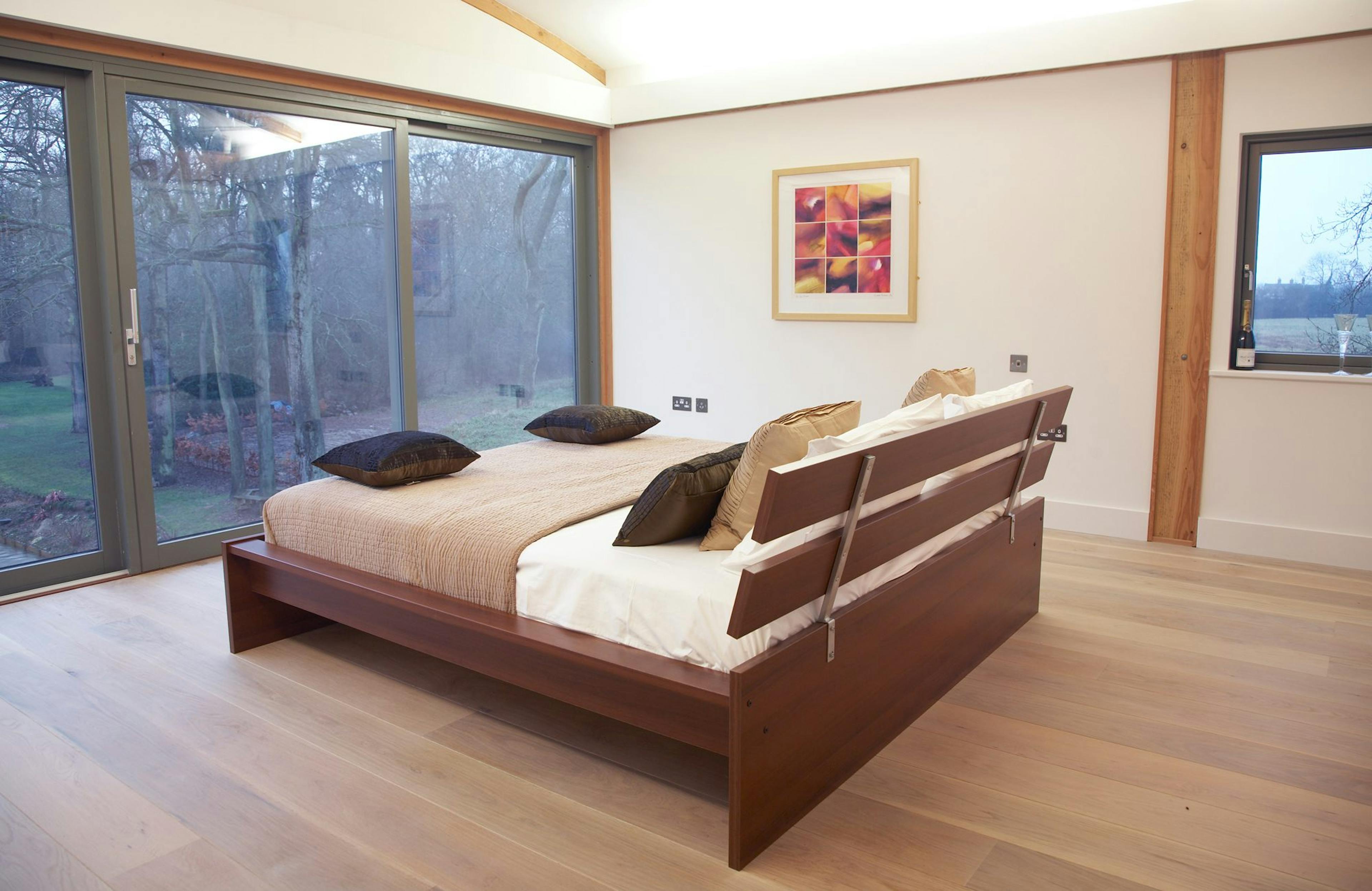 Bedroom with Expansive Glazing Offering Panoramic Garden Views